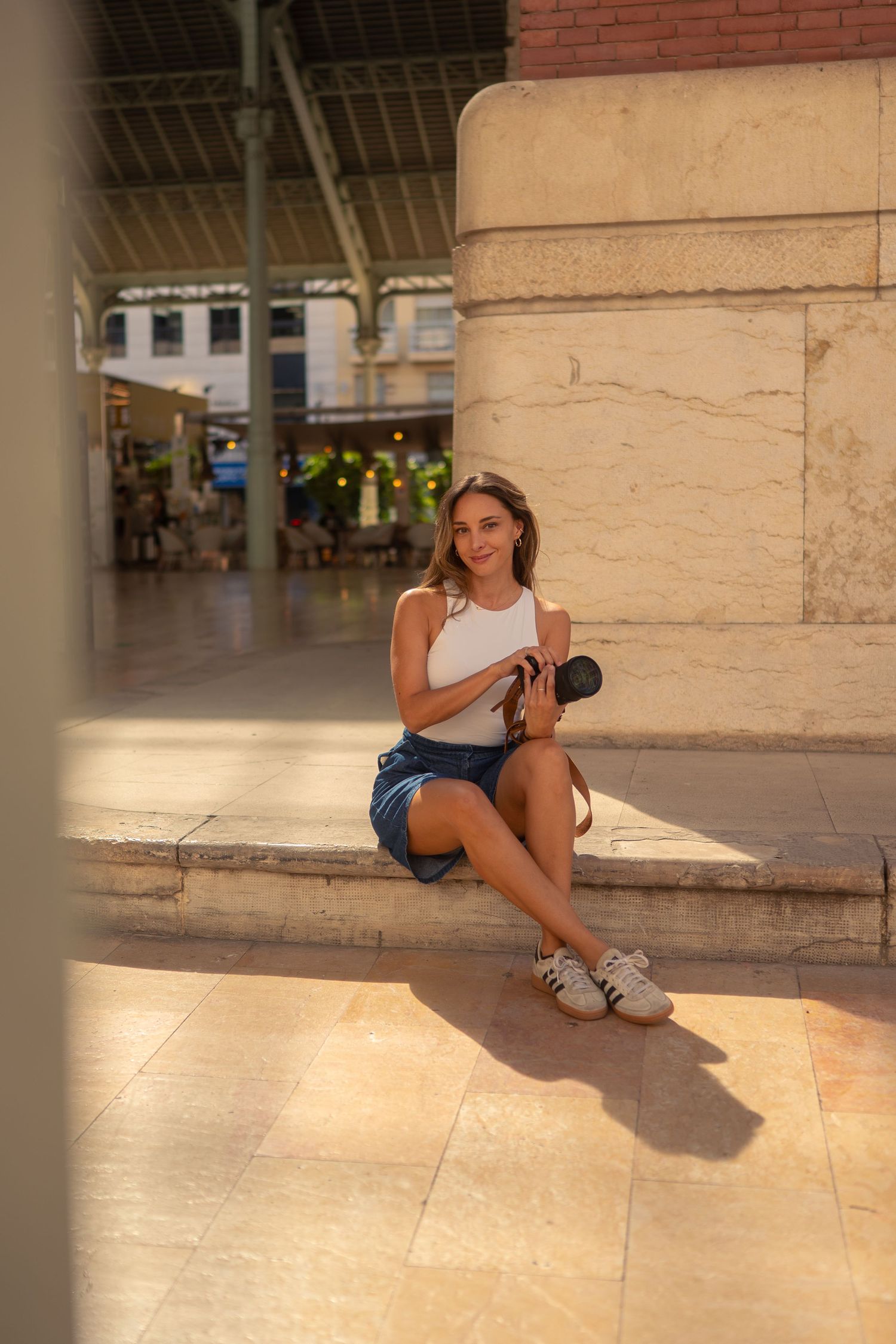 Branding photo session for a photographer in the city of Valencia. Holding her camera in the hand