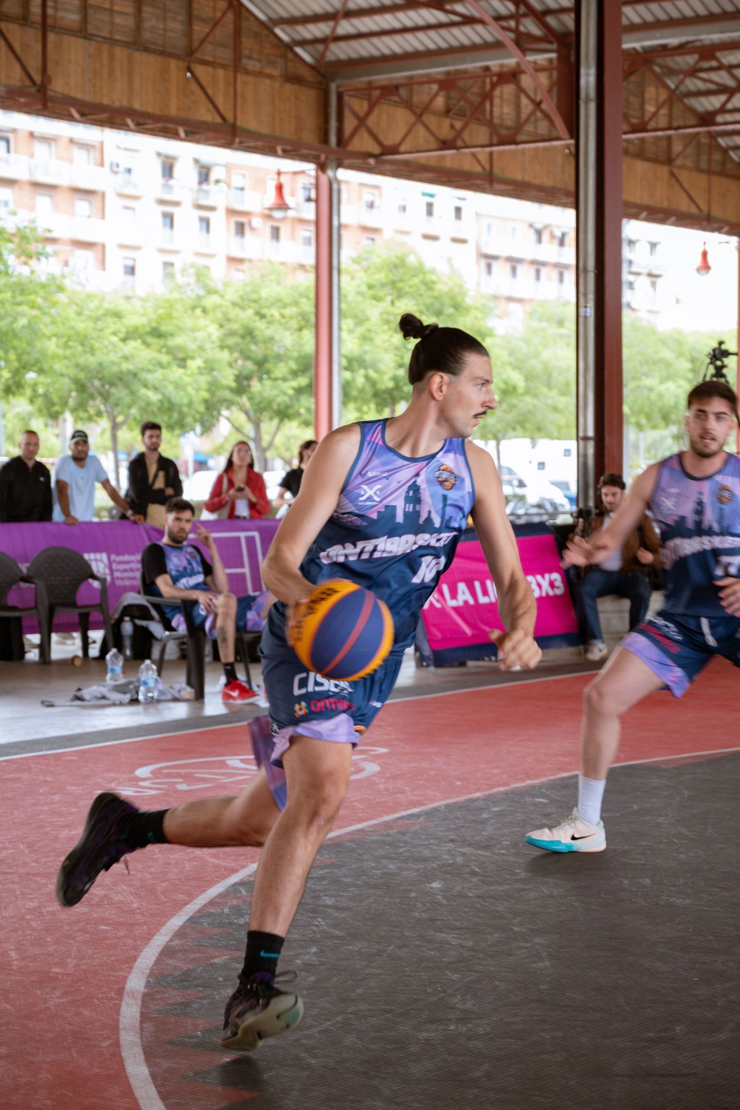 Basketball player dribbling during a 3x3 street basketball tournament.