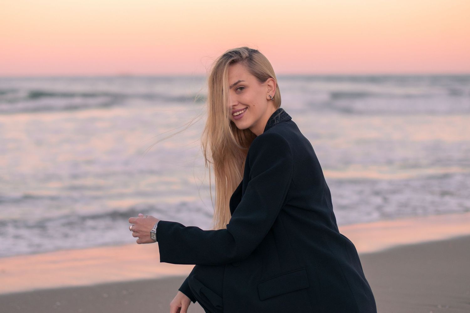 a model embraces on beach during golden sunset.