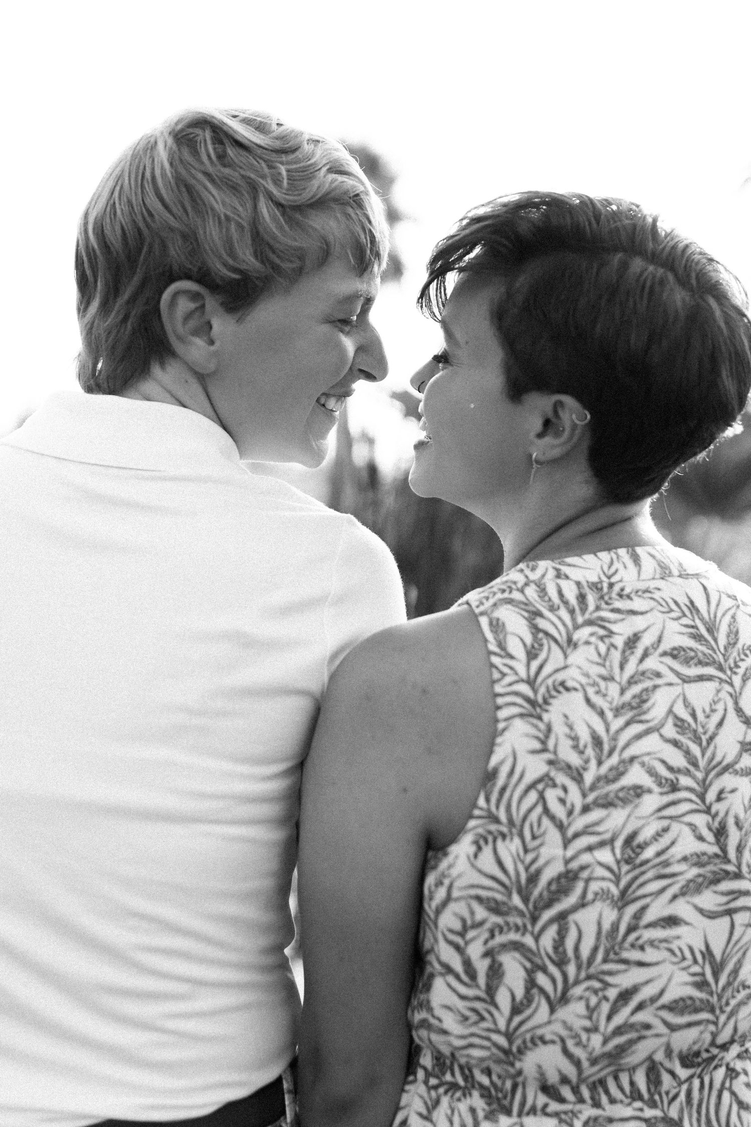 A close-up series of intimate poses between two people wearing white and patterned outfits.