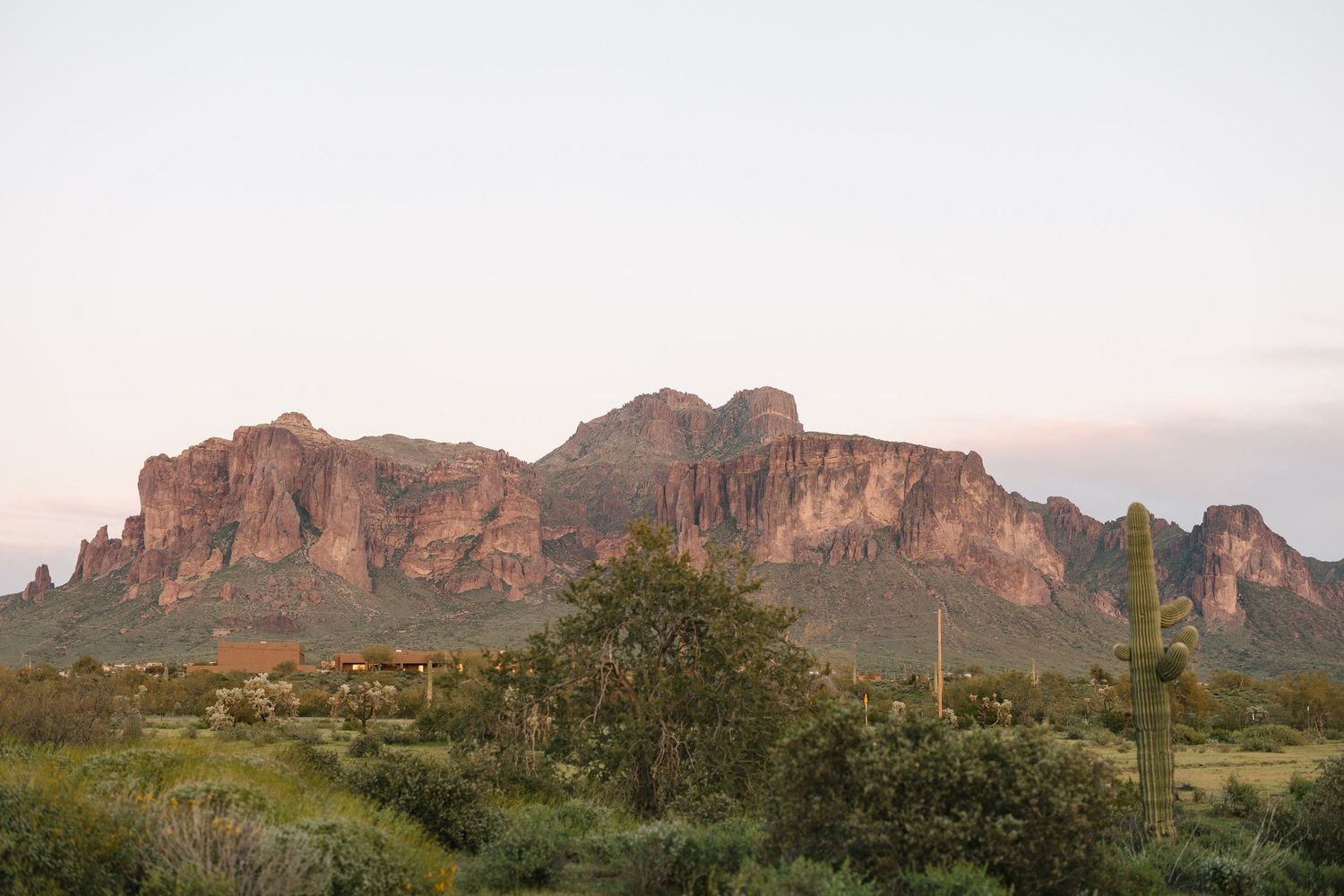 Majestic red rock mountain formation in Arizona desert landscape at sunset.