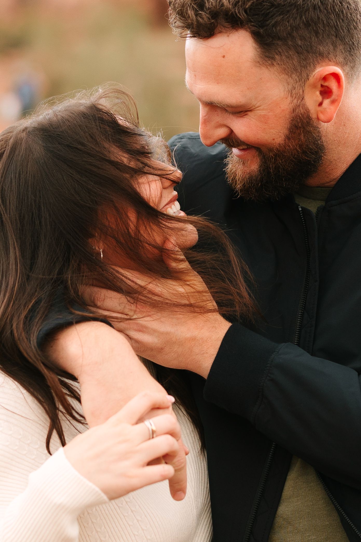 A tender moment captured in a sequence of five photos showing a couple in an intimate embrace outdoors.