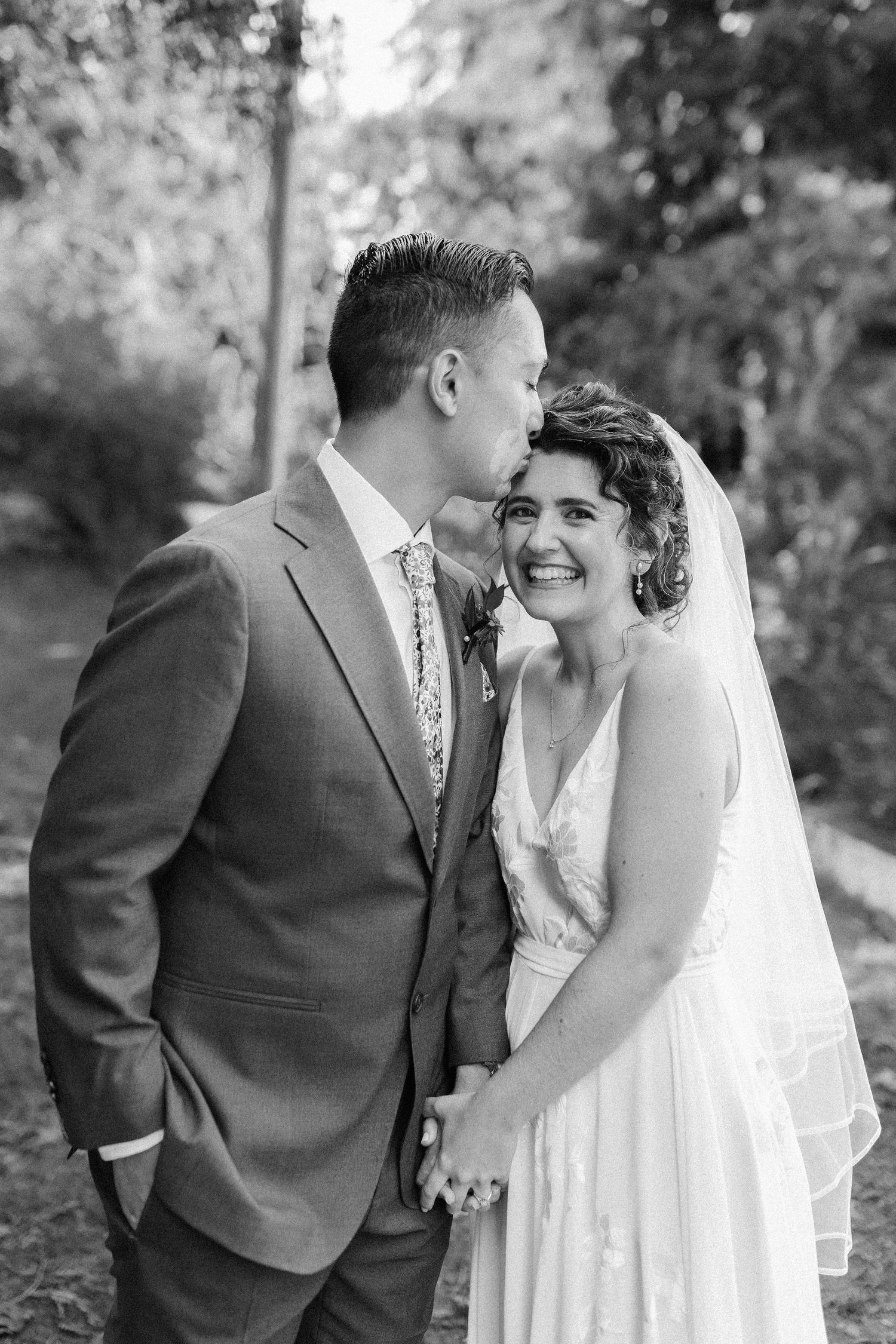 Newlyweds share sweet moments together during outdoor wedding photo session. Molly McPhoto