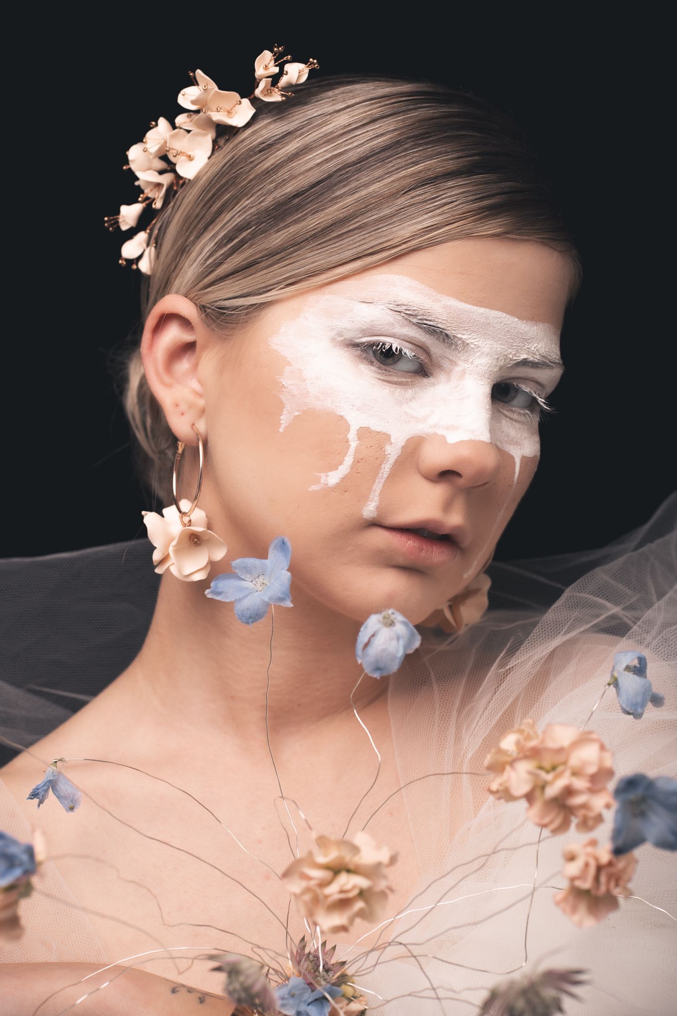 A refined and artistic studio bridal portrait featuring muted dried flowers and delicate accessories. Modern and timeless styling.