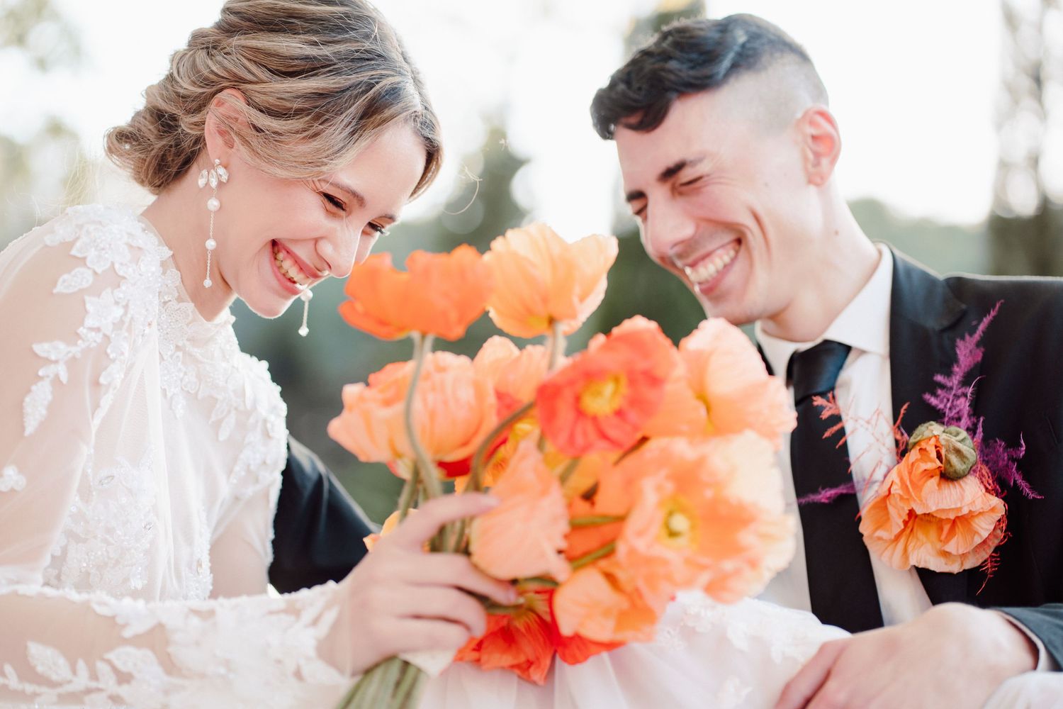 Joyful wedding moment with coral flowers and natural light.