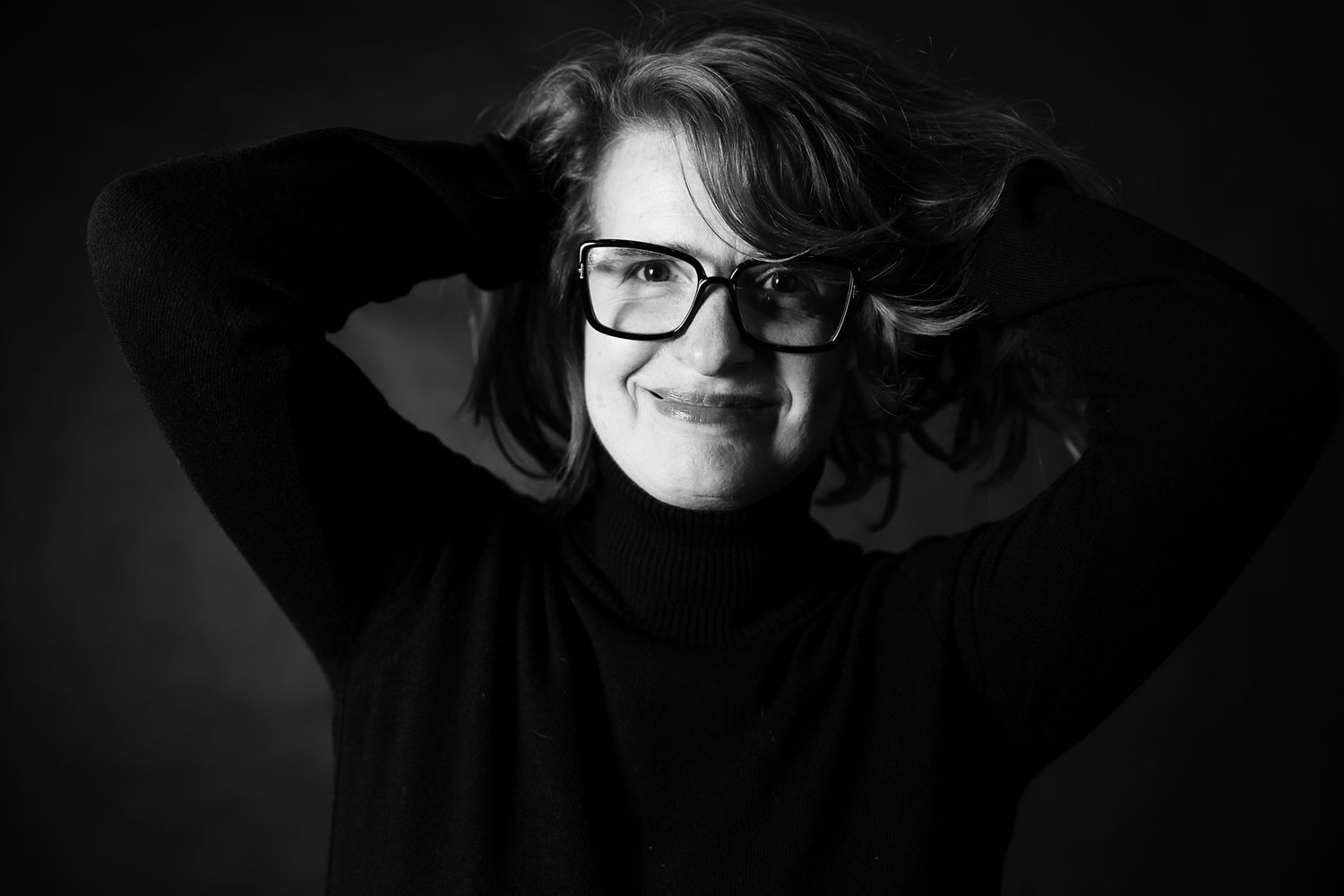Moody black and white portraits featuring contemplative poses in low light.