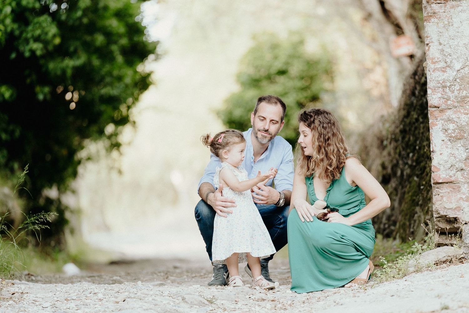 A joyful family moment captured outdoors against a soft natural background.