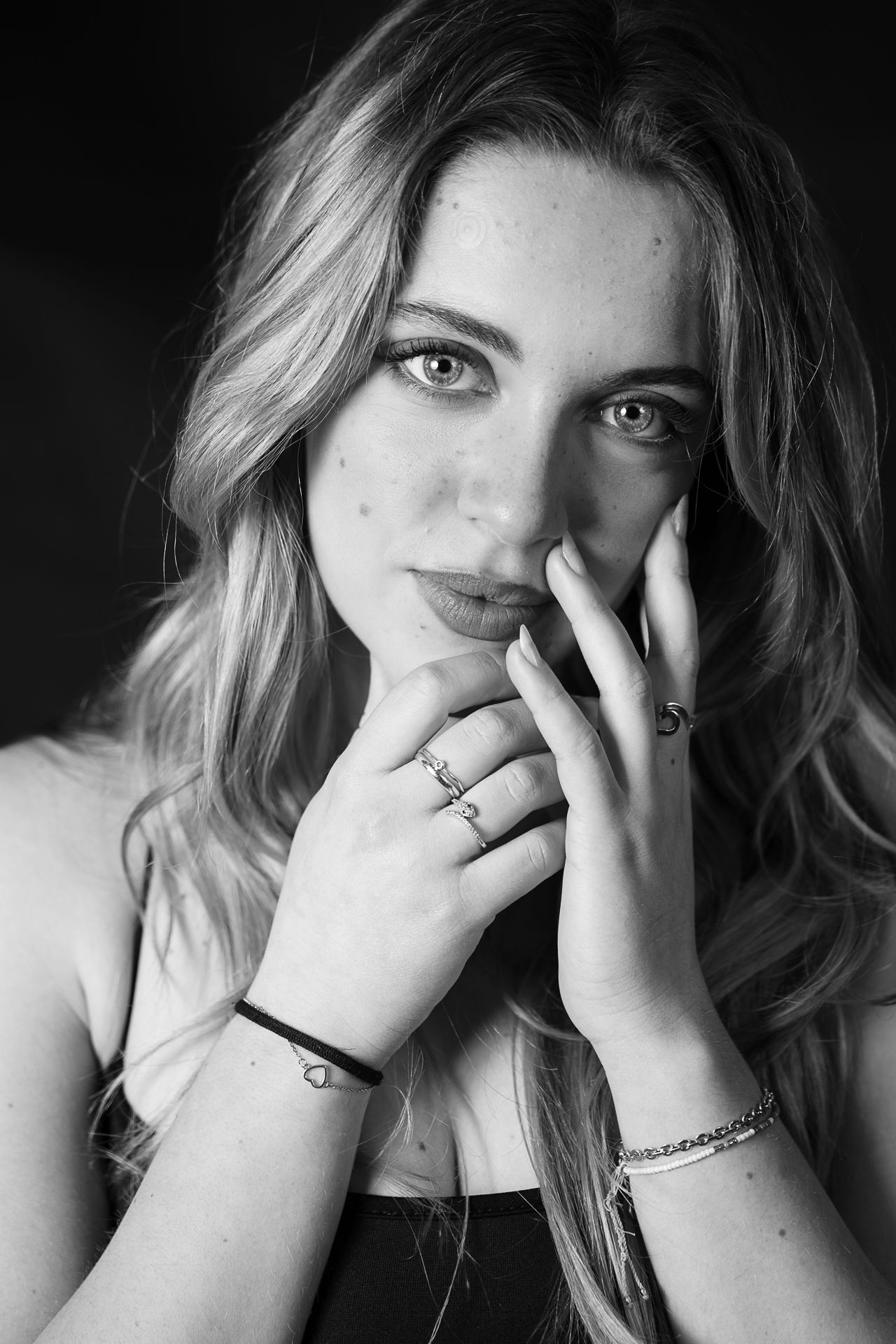 Black and white portrait series showing expressive hand gestures and emotions.