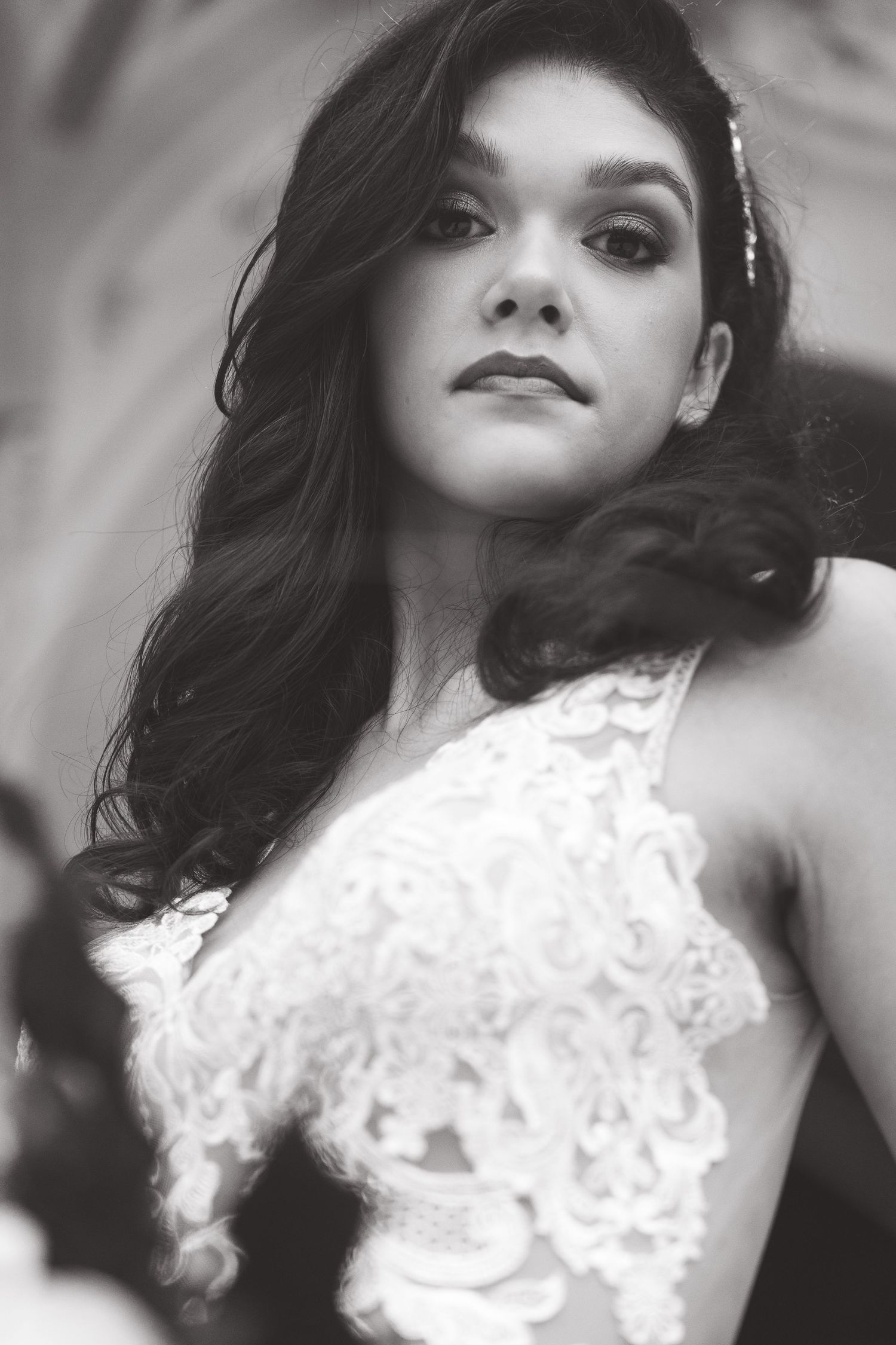Close-up bridal portrait in black and white featuring delicate lace details.