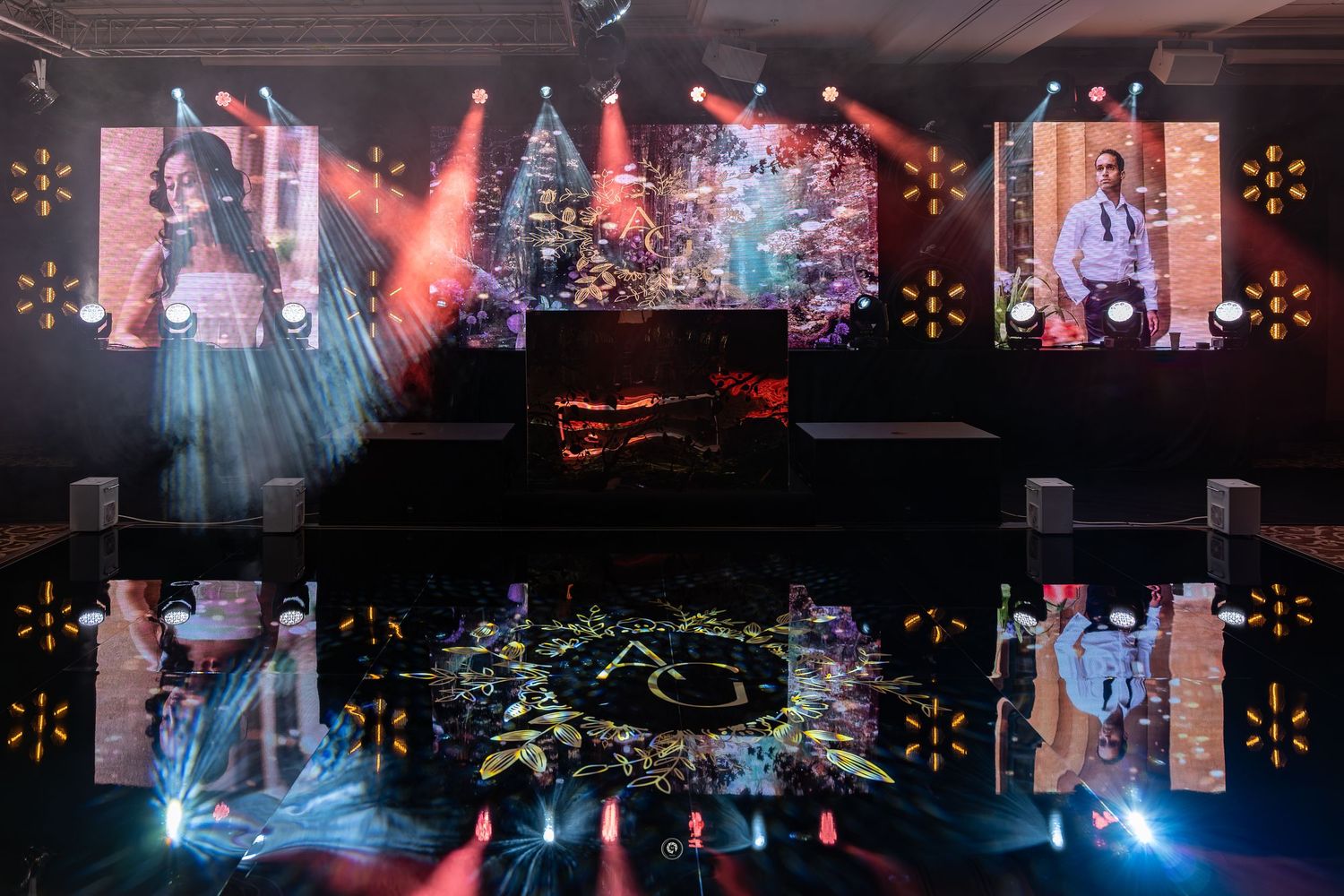 Concert stage with colorful lighting effects and fog machines creating an atmospheric performance environment.