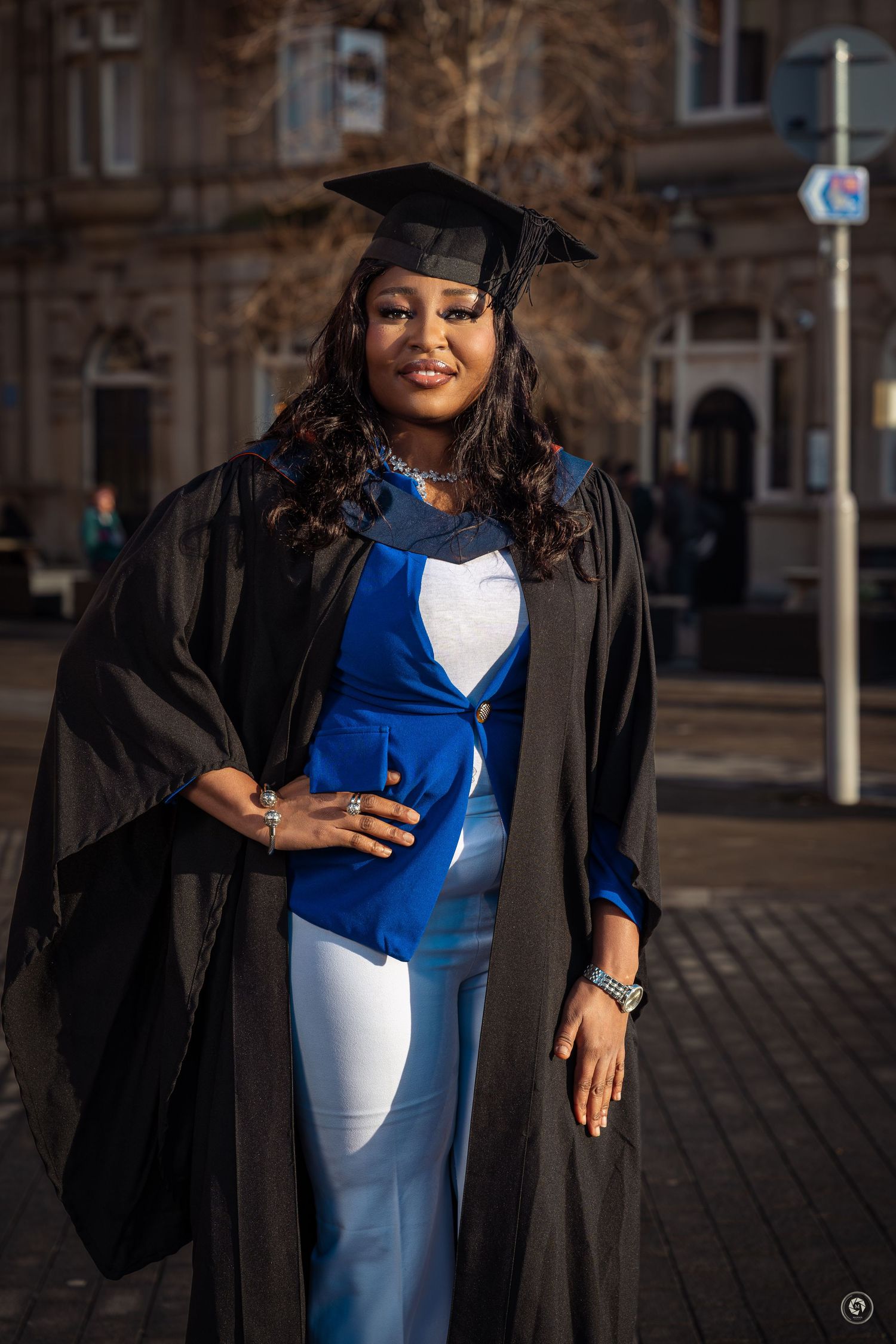 A series of graduation photos showing a graduate in a black cap and gown with blue and white dress outdoors.