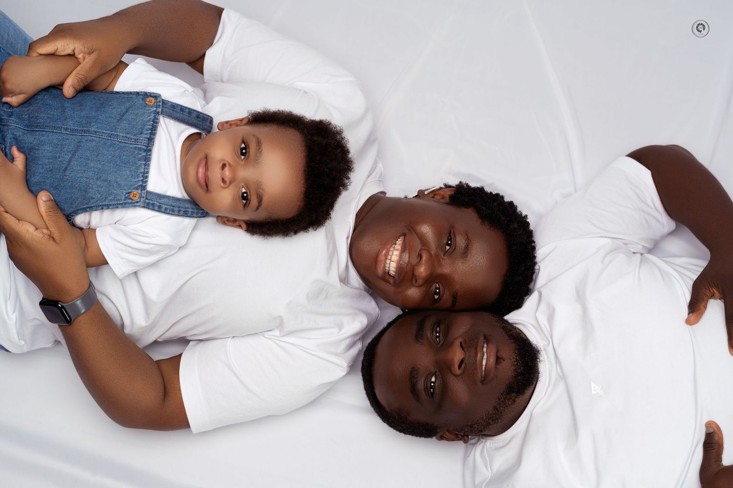 A series of connected photos showing someone in a white shirt lying down against a white background.