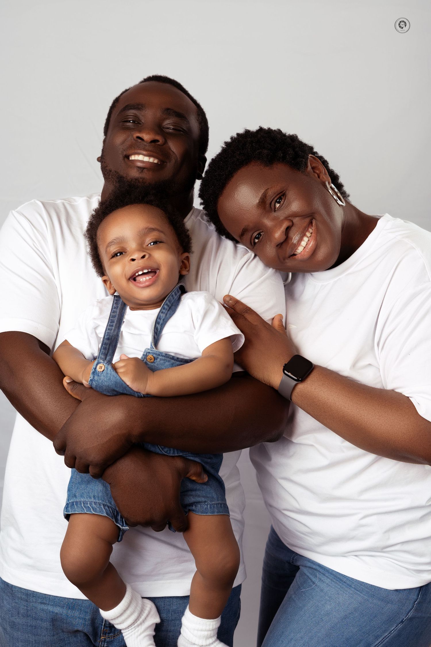 A heartwarming family photo series showing joyful moments between parent and child in matching white shirts and denim.
