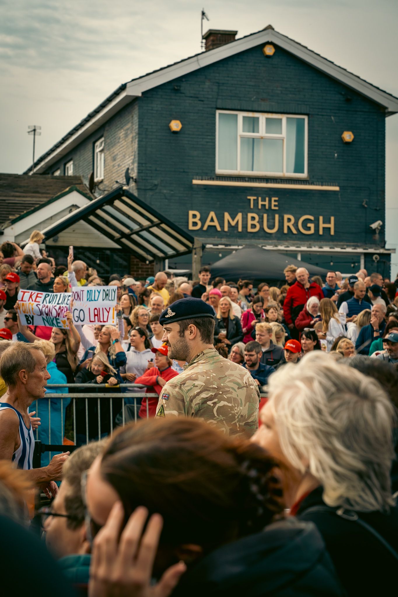 Large crowd gathered outside The Bamburgh pub building during an event.