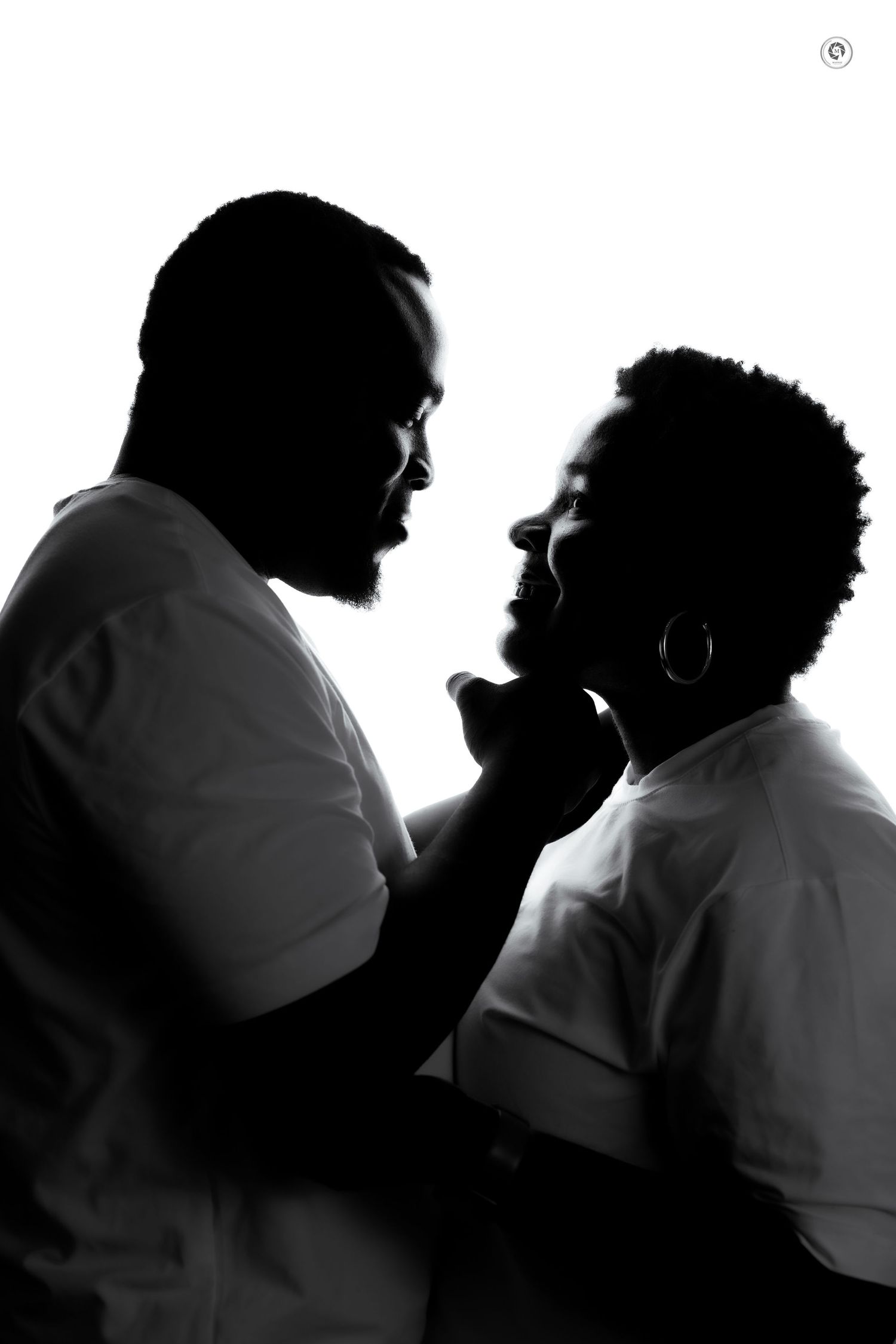 Silhouetted figures in a sequence of black and white frames show an intimate romantic moment between two people.