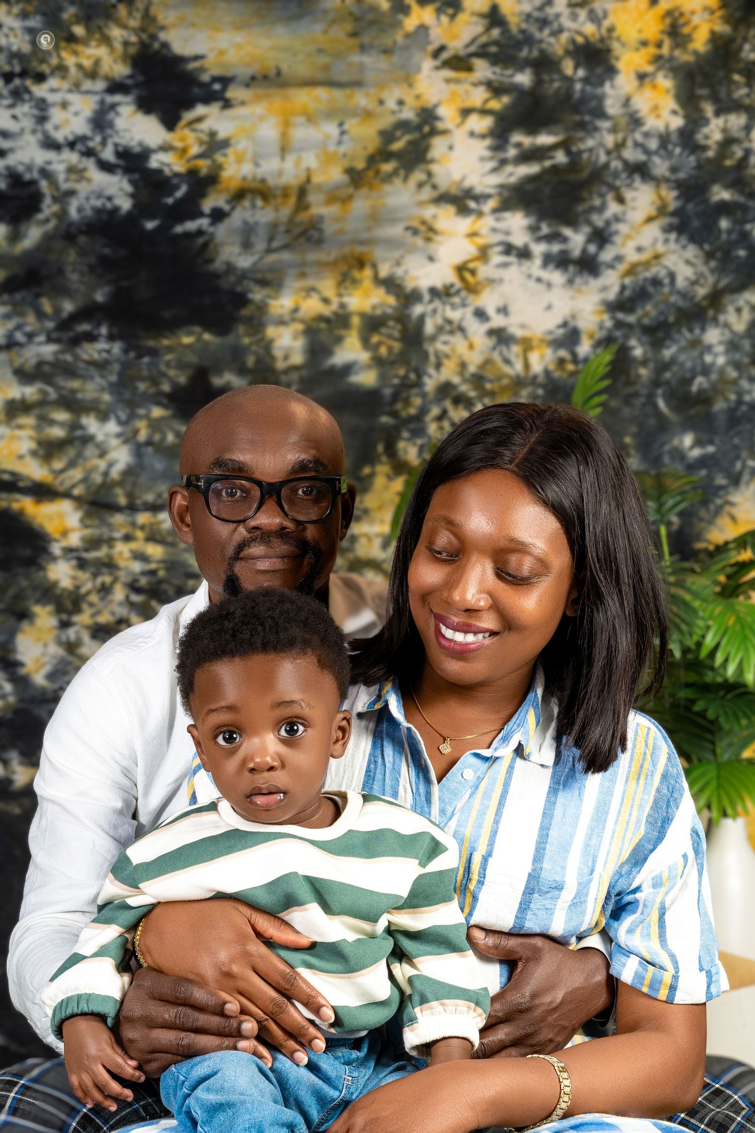 A series of heartwarming family portraits captured against a textured backdrop with yellow and gray tones.