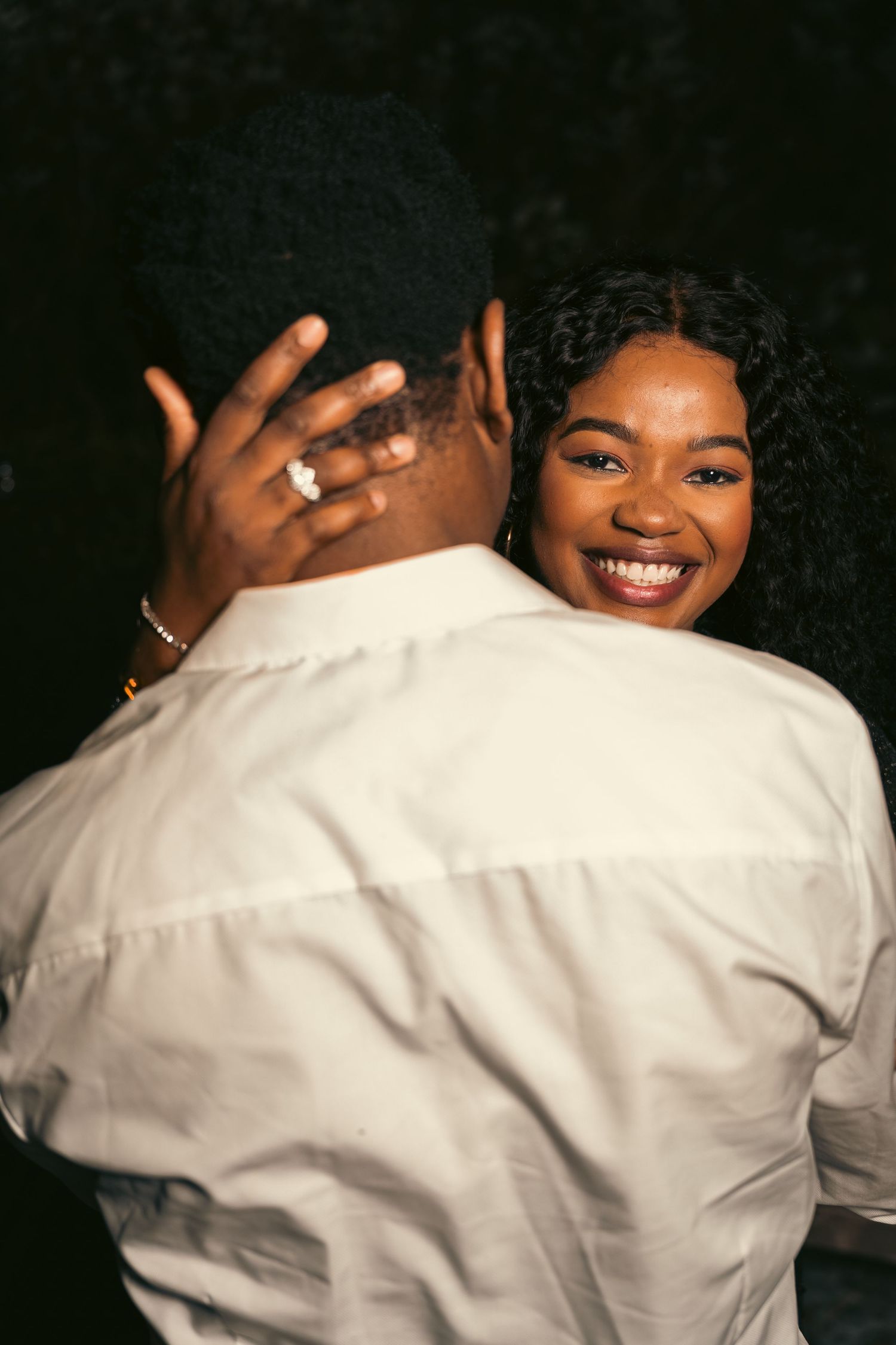 A series of candid photos showing a couple embracing and smiling together against a dark background.