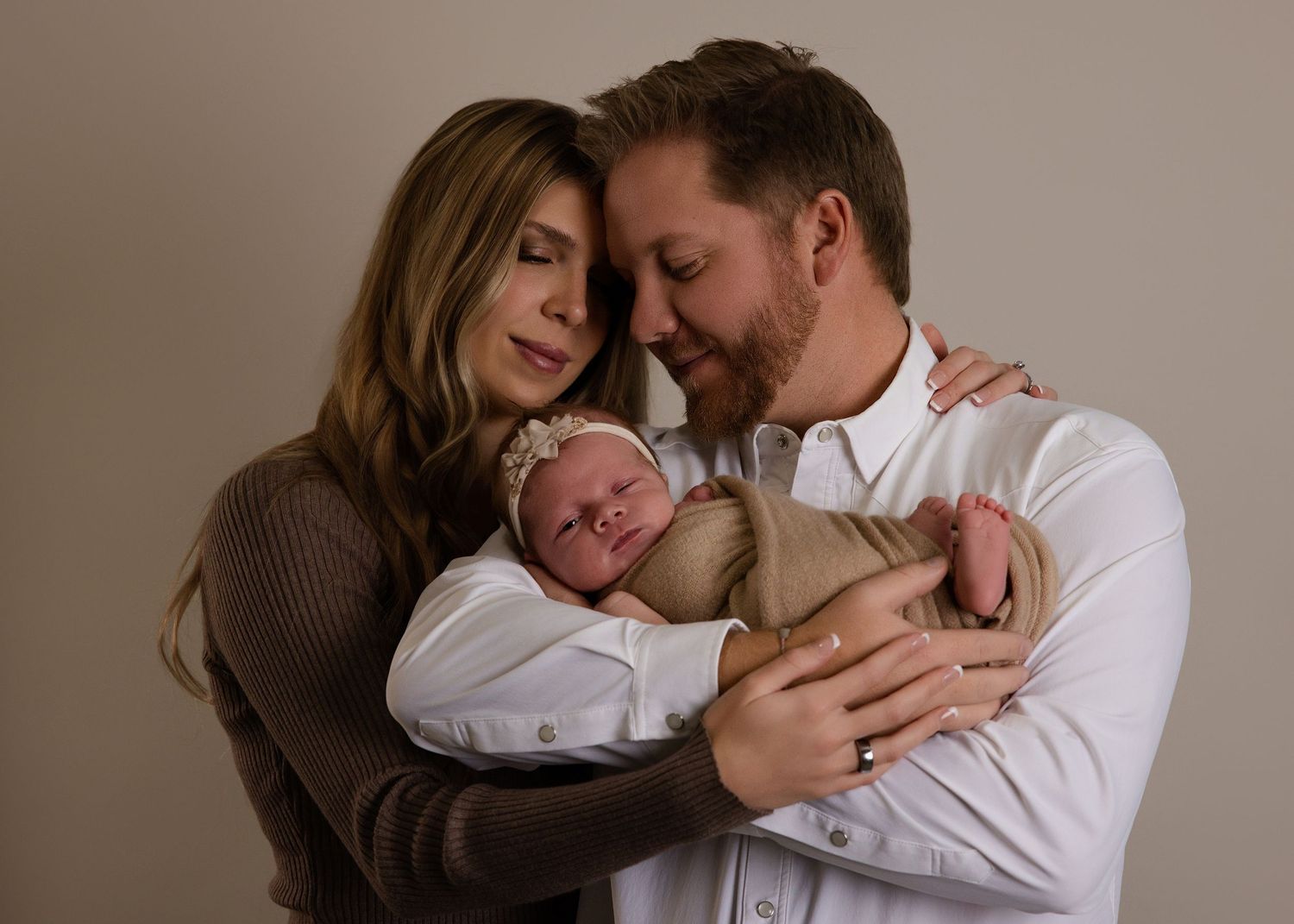 Natural newborn photography with parents in bright Utah home nursery