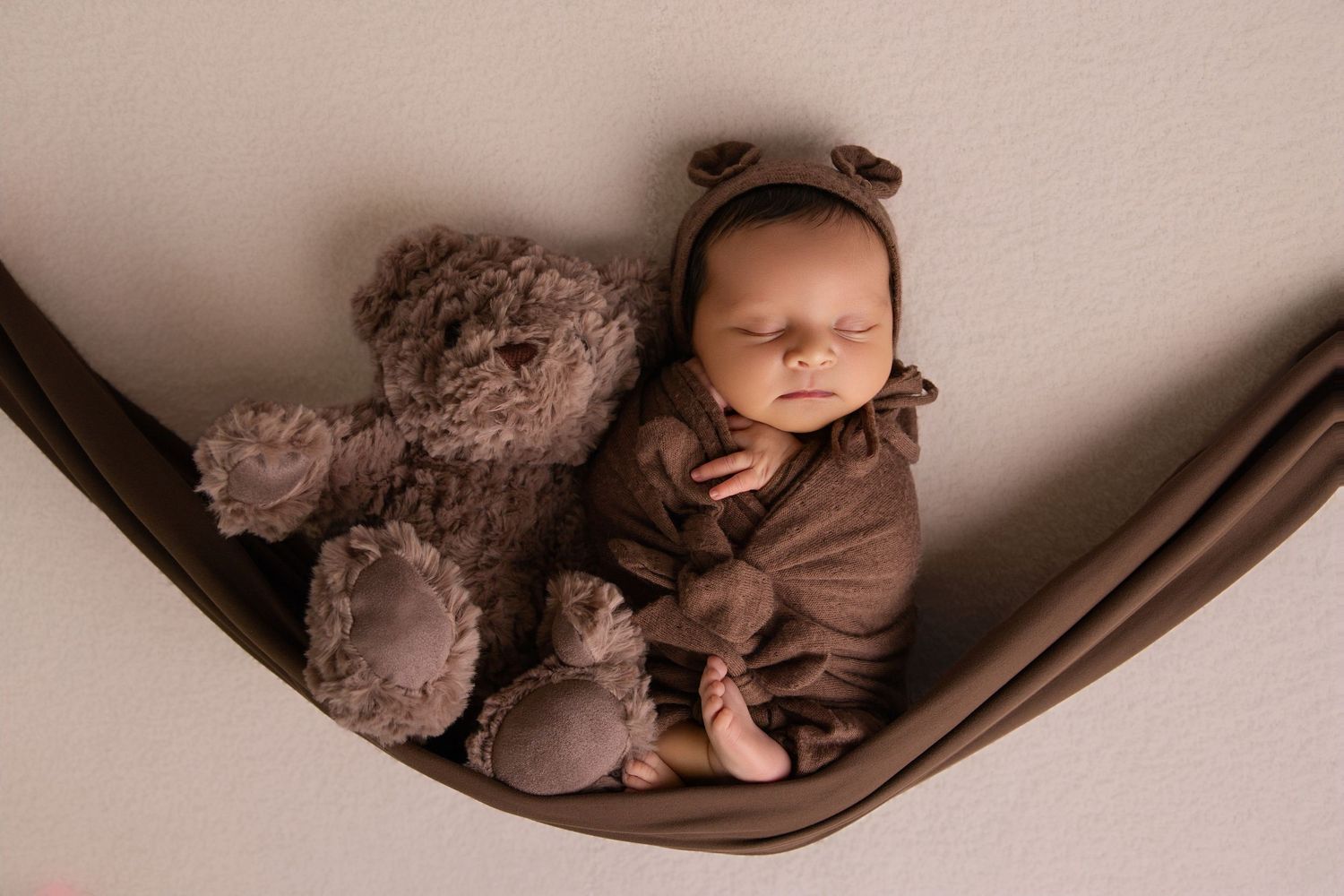 Studio newborn photo of baby swaddled in soft neutral tones by Utah photographer Leah Louviere