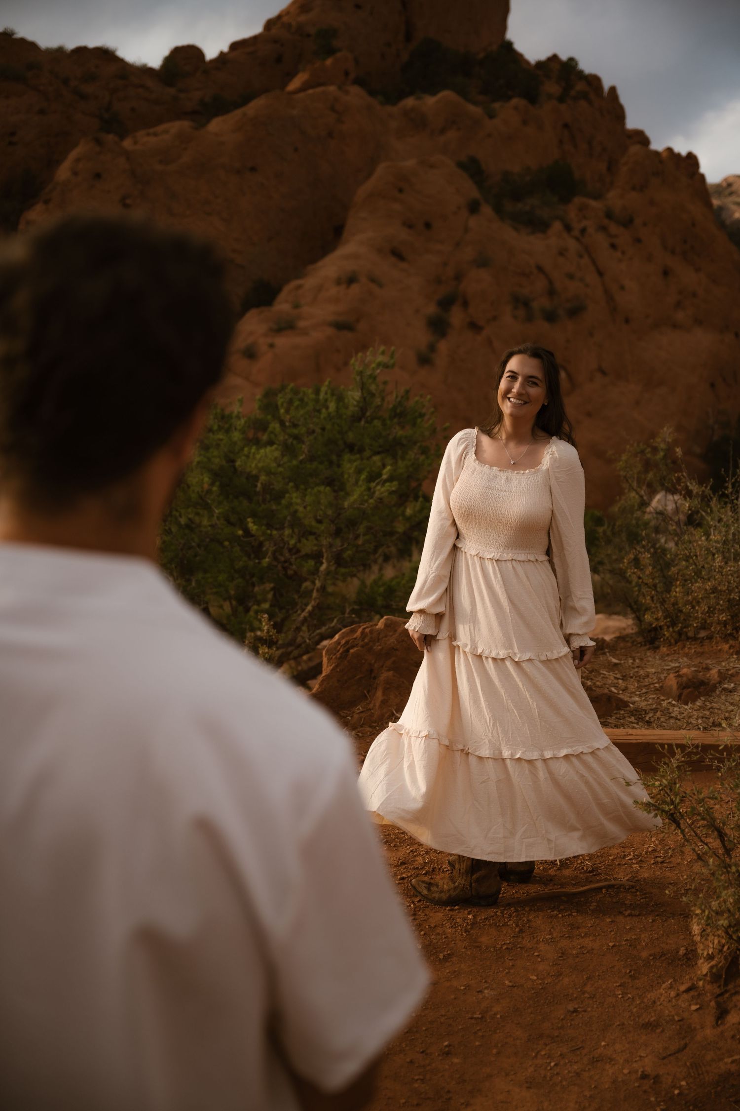 Romantic desert engagement session with red rock formations as backdrop.