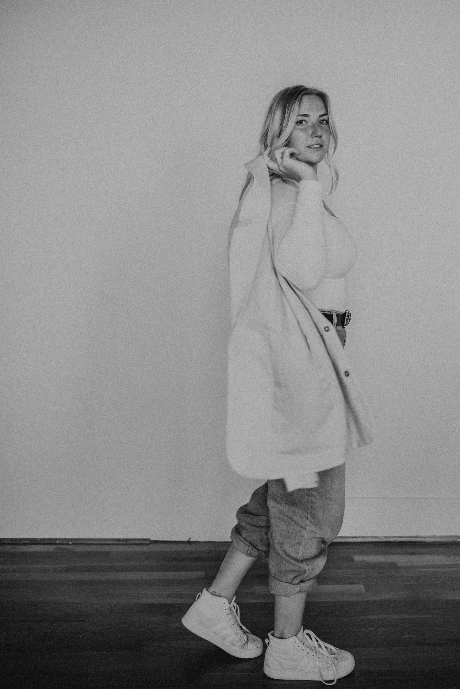 Black and white series of a child playing and moving in casual clothes.