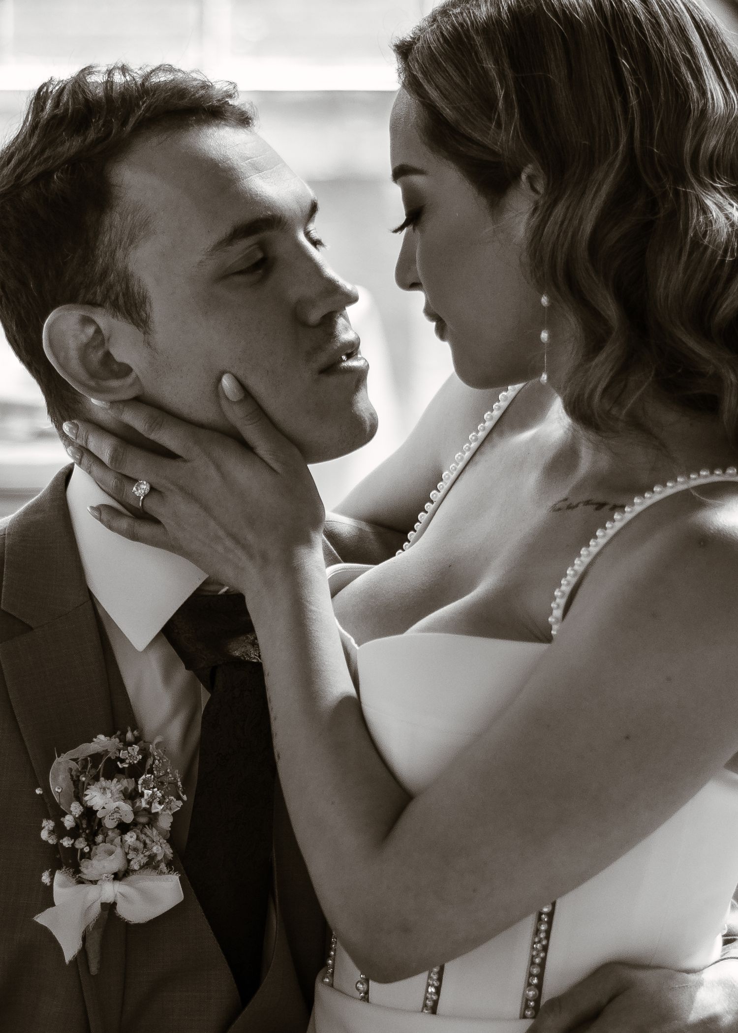 A romantic black and white portrait of a Bride and Groom sharing an intimate moment in wedding dress during couples portraits