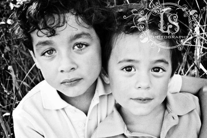 Black and white portrait series showing two children embracing.