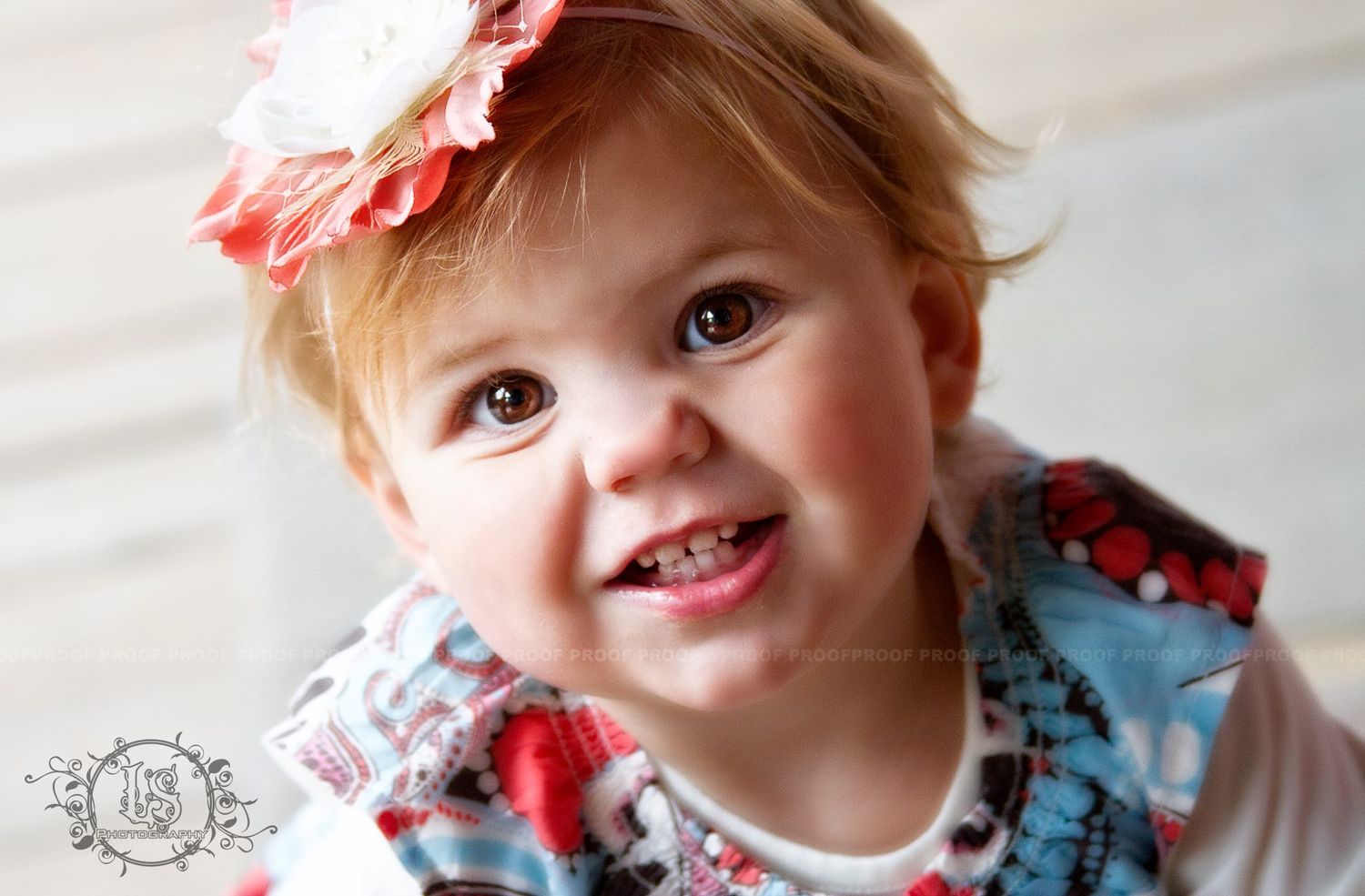 Portrait series of toddler wearing floral accessories and showing joyful expressions.