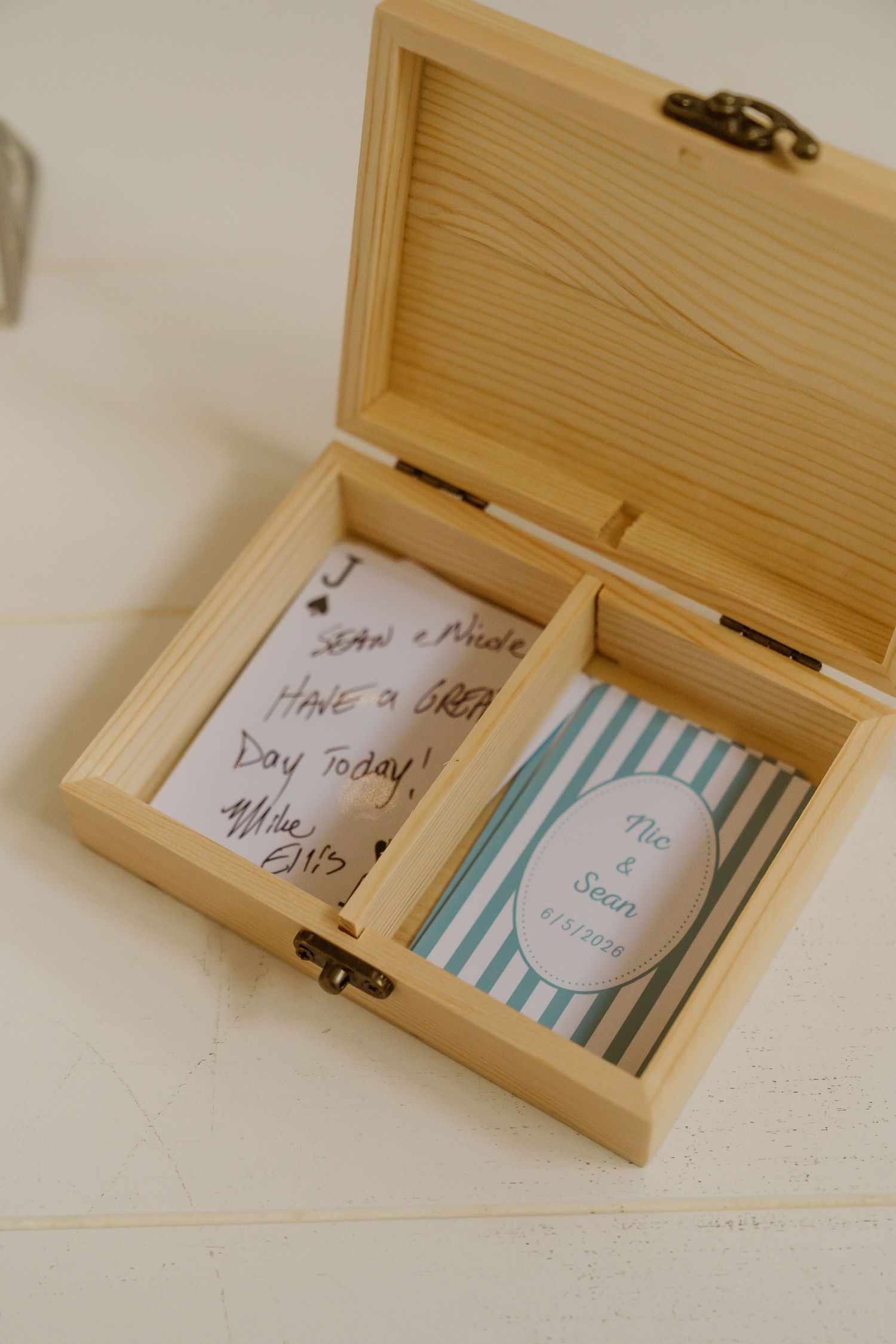 Personalized wooden keepsake box with custom playing cards and handwritten wedding messages.