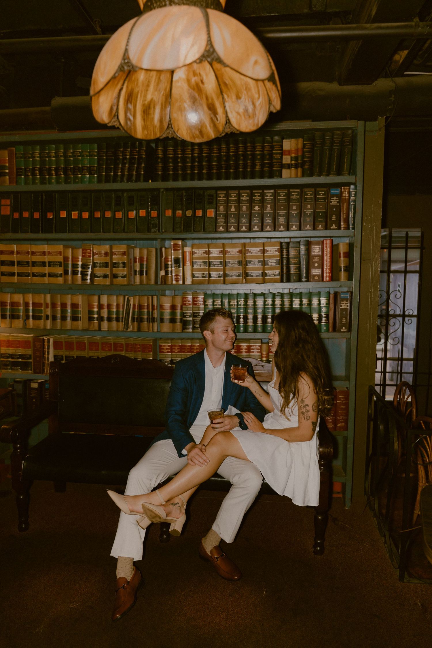 Dancing sequence in a vintage library with wall-to-wall bookshelves.