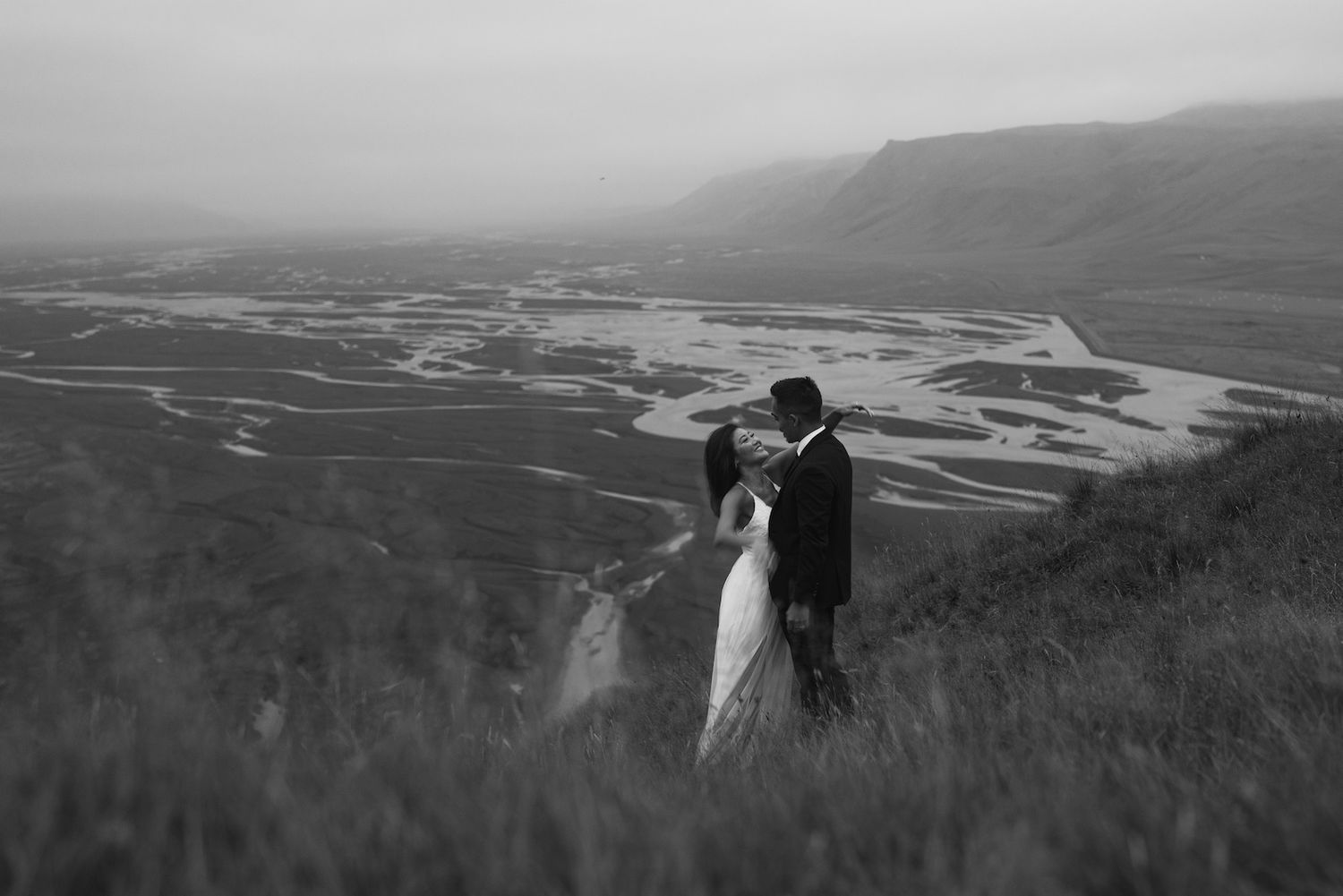 Happy couple in love with beautiful views on a braided river in iceland