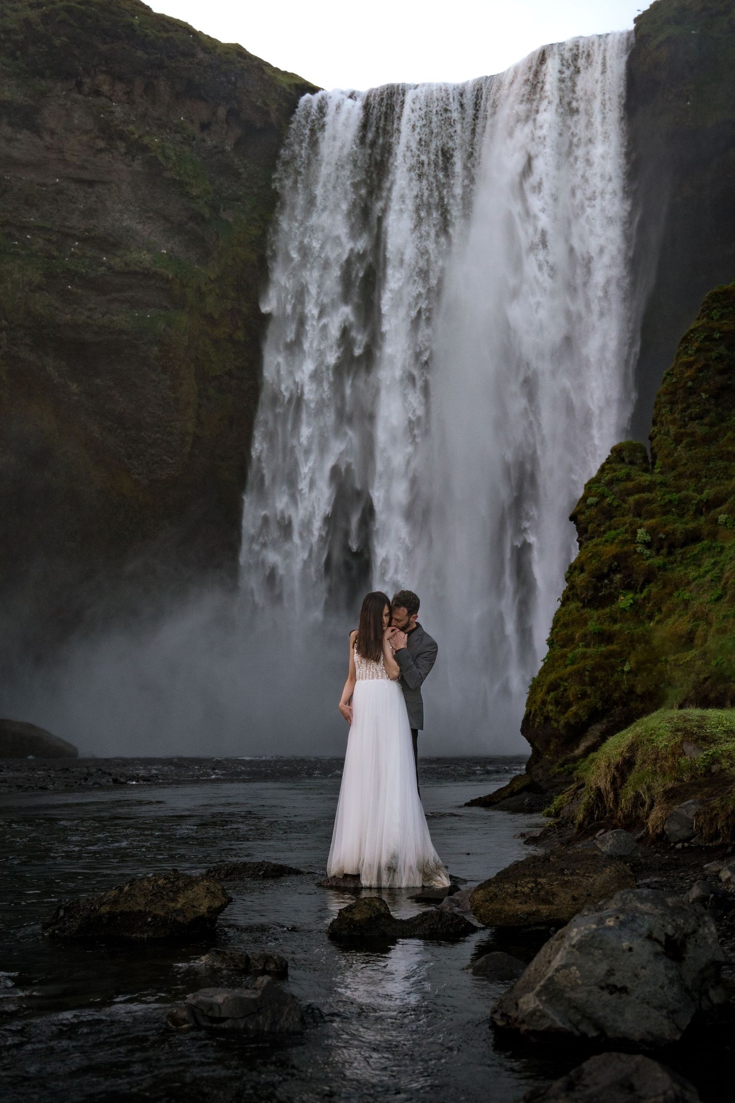 Elopement couple in front of Skógafoss waterfall in Iceland