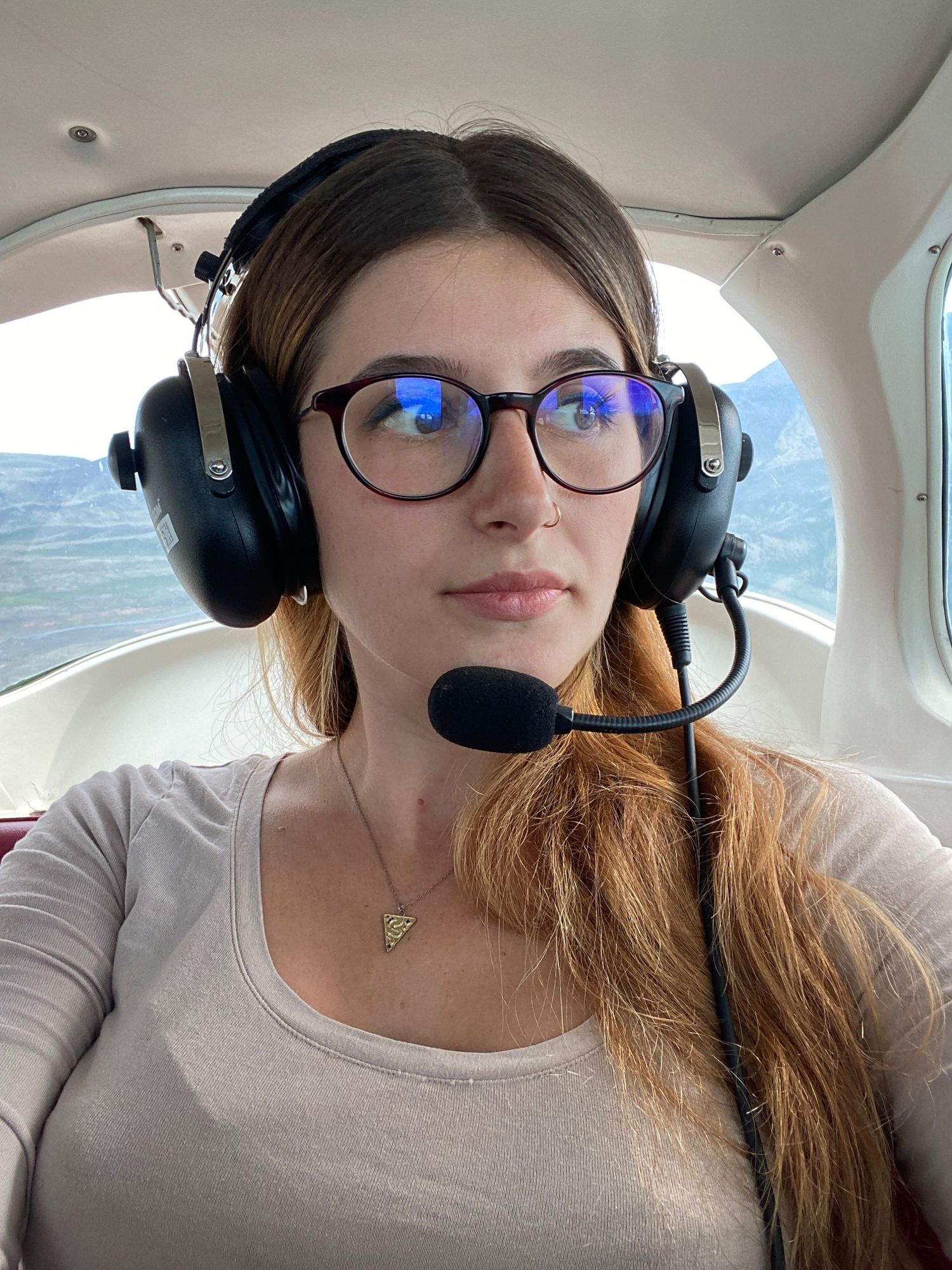 portrait of photographer in aircraft by Love & Lava Photo