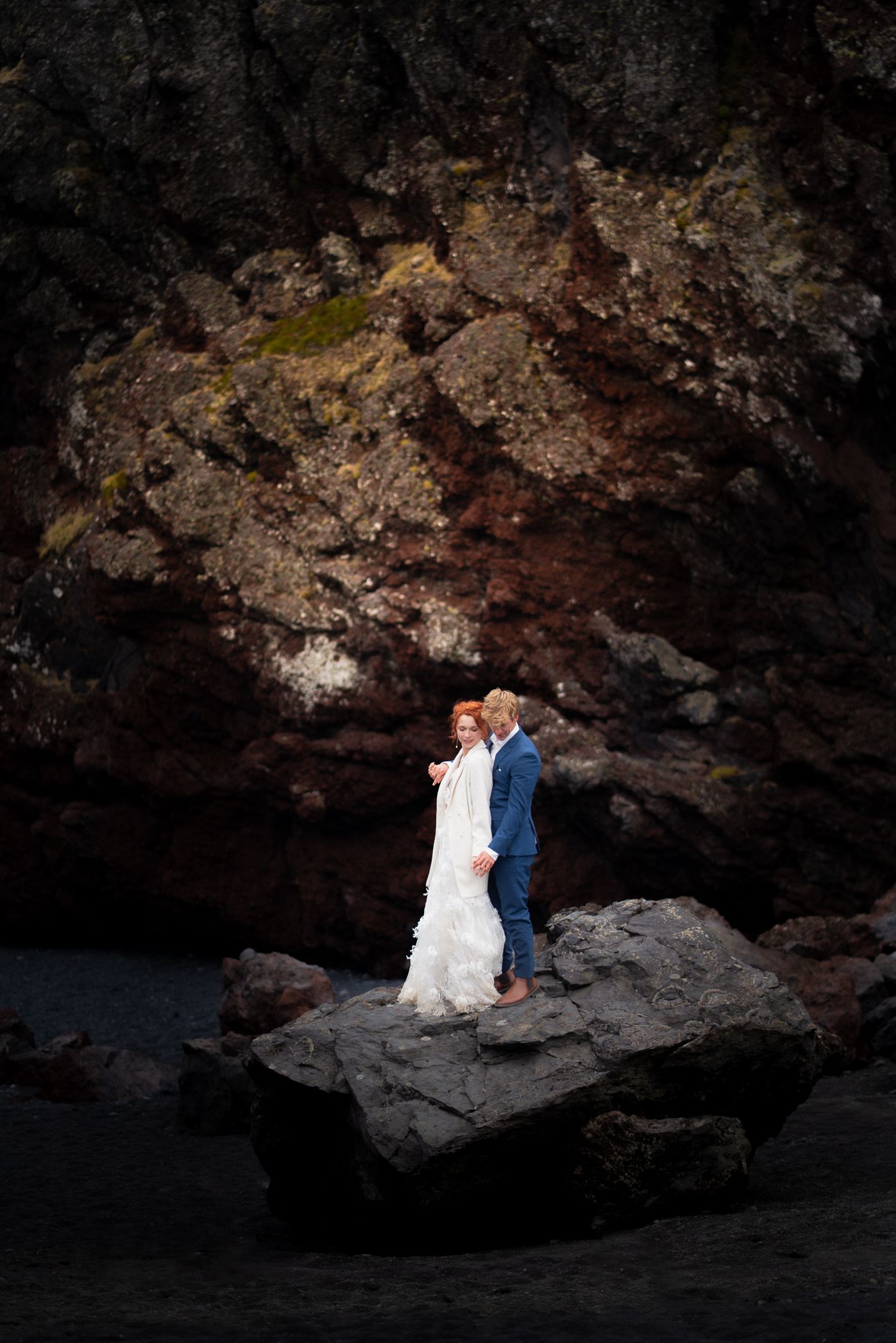 Elopement couple sharing an intimate moment on volcanic rocks in Snæfellsnes Iceland
