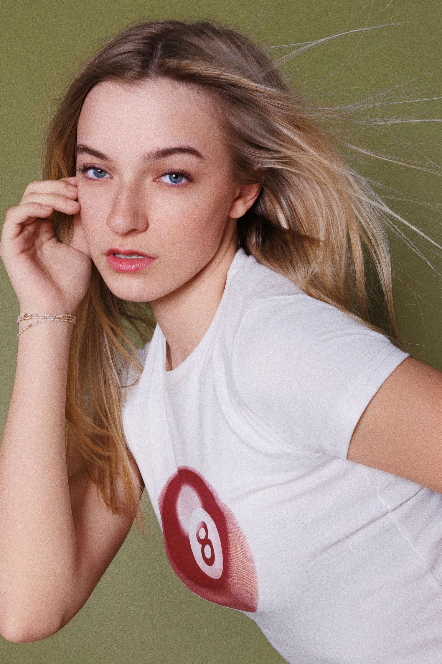 A sequence of fashion portraits showing dynamic poses with flowing blonde hair against an olive green background.