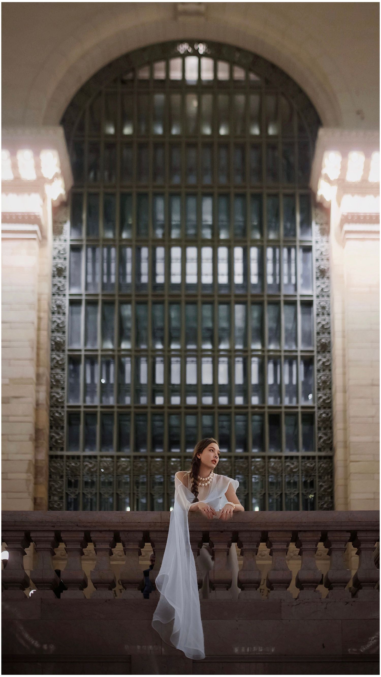 A series of cinematic shots showing a person in a flowing white dress against ornate iron railings and arches.