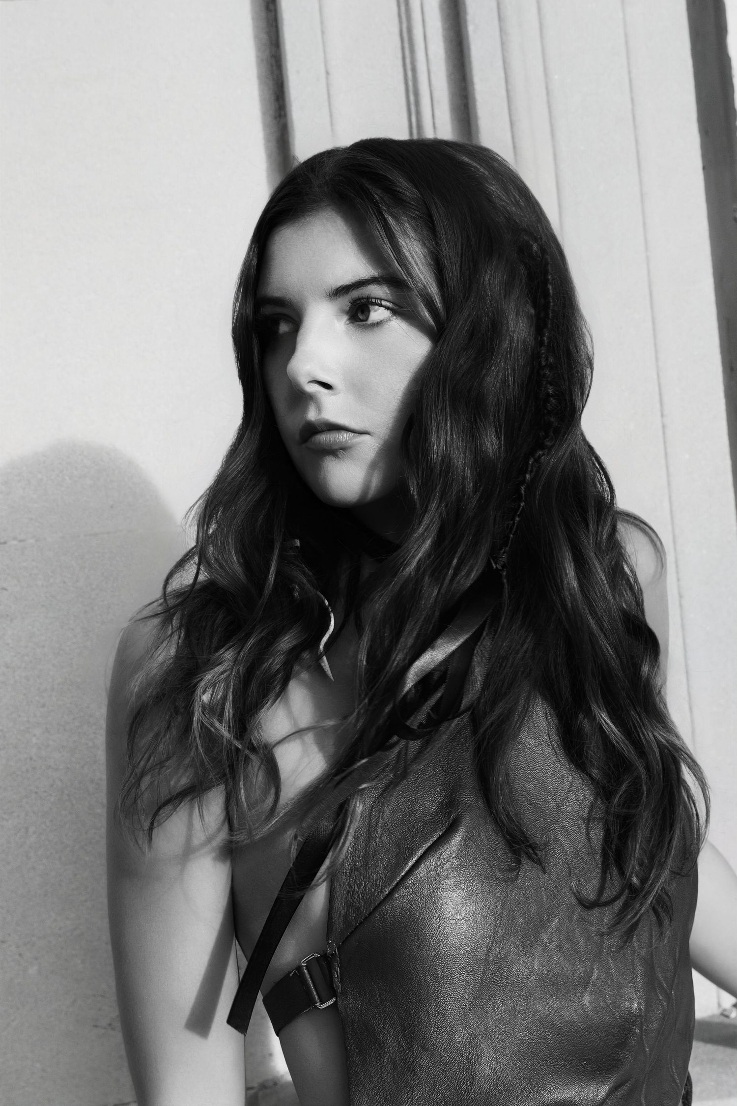 A series of black and white profile photos showing a person with dark wavy hair against a light background.