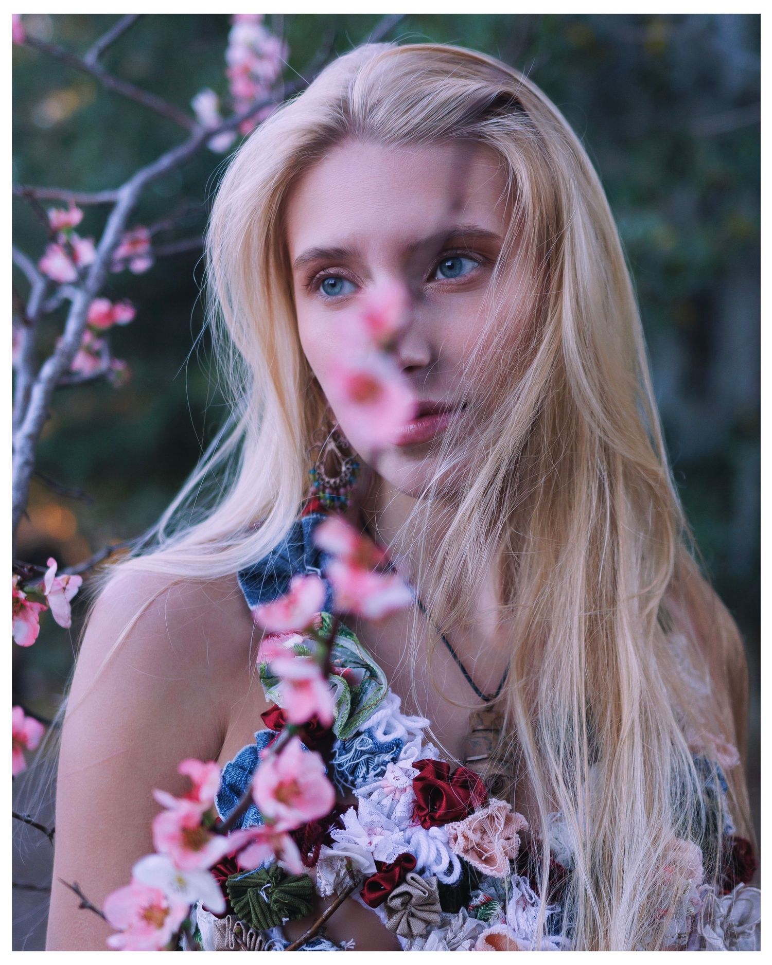 Ethereal artistic portrait series with pink cherry blossoms framing a dreamy springtime composition against a moody background.