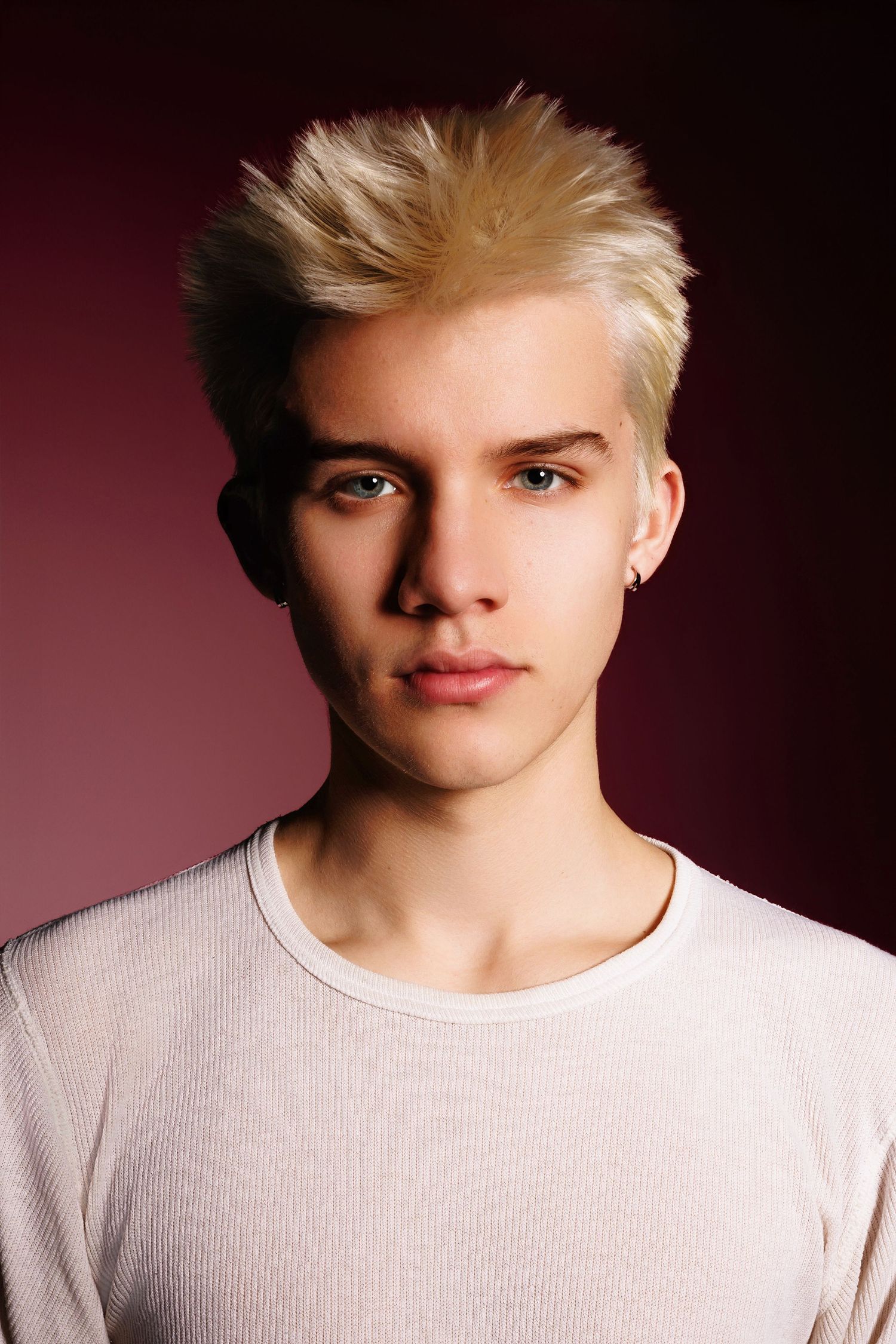 A series of portraits showing a person with blonde hair in a white shirt against a dark background.