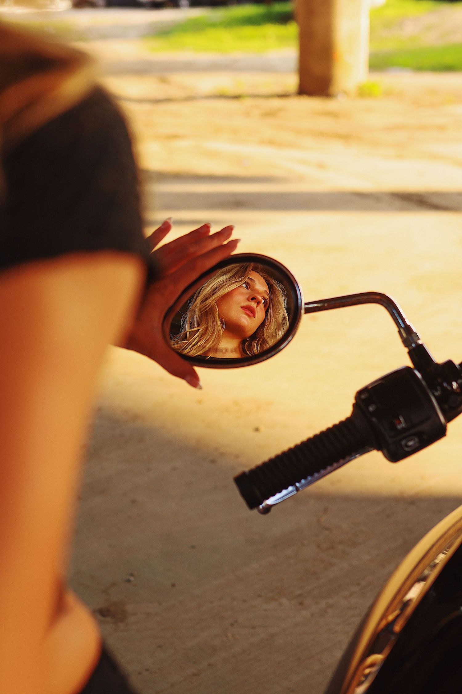 A series of motorcycle side mirror reflections showing glimpses of a rider in golden sunlight.