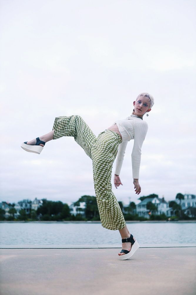 A sequence of dance movements showing a person in green checkered pants performing fluid motions by a waterfront.