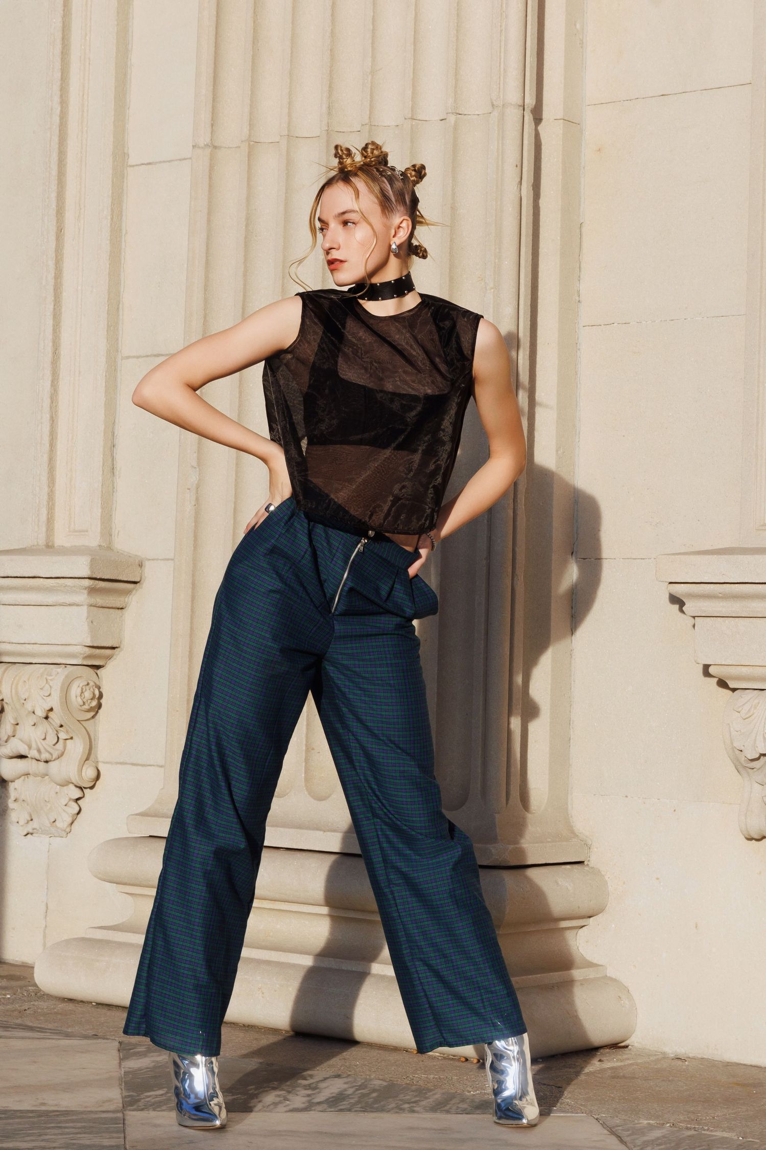 Five fashion photos showing high-waisted navy wide-leg pants paired with sheer black top and metallic shoes.