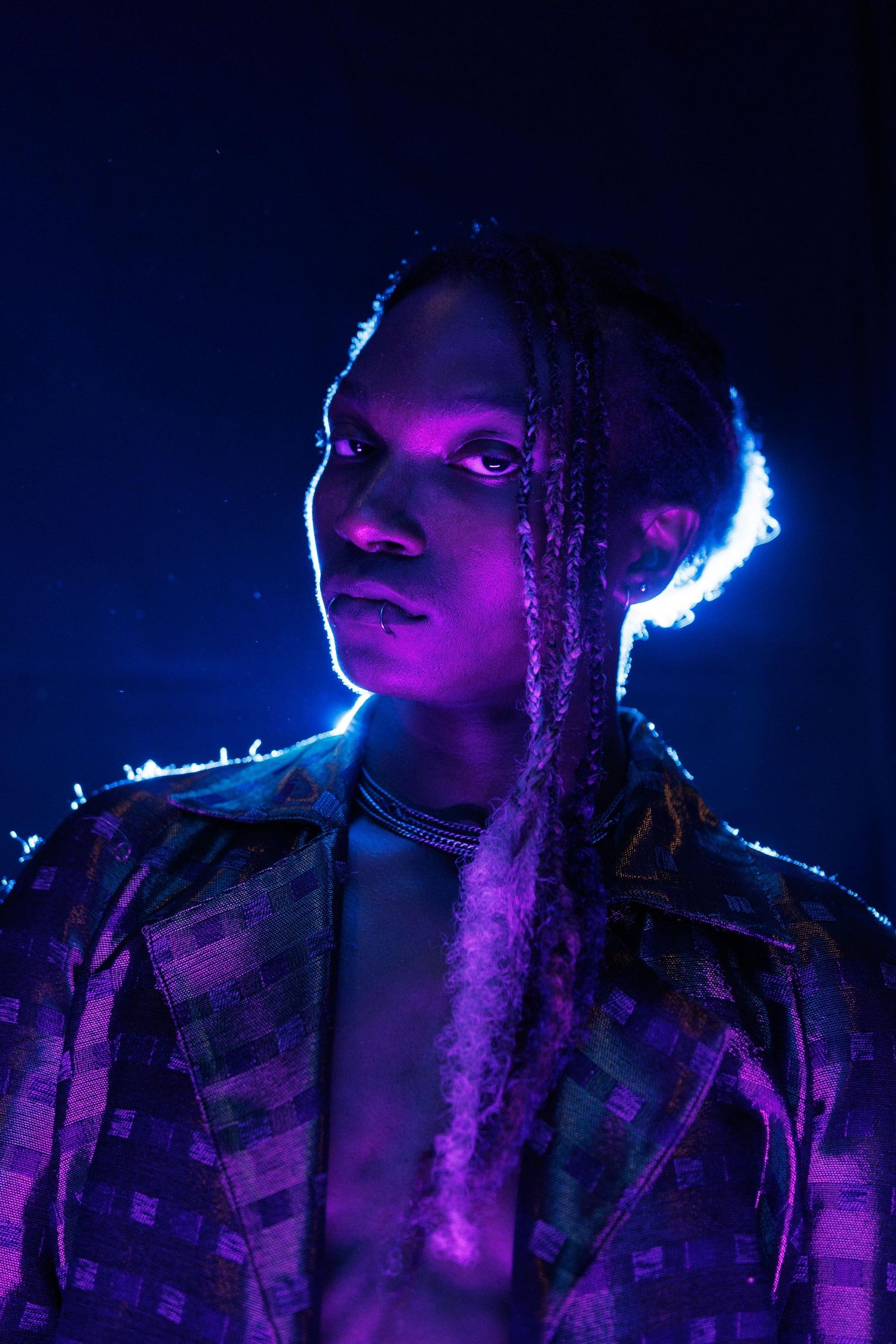 A profile portrait in neon purple and blue lighting creates a dramatic cyberpunk aesthetic effect.