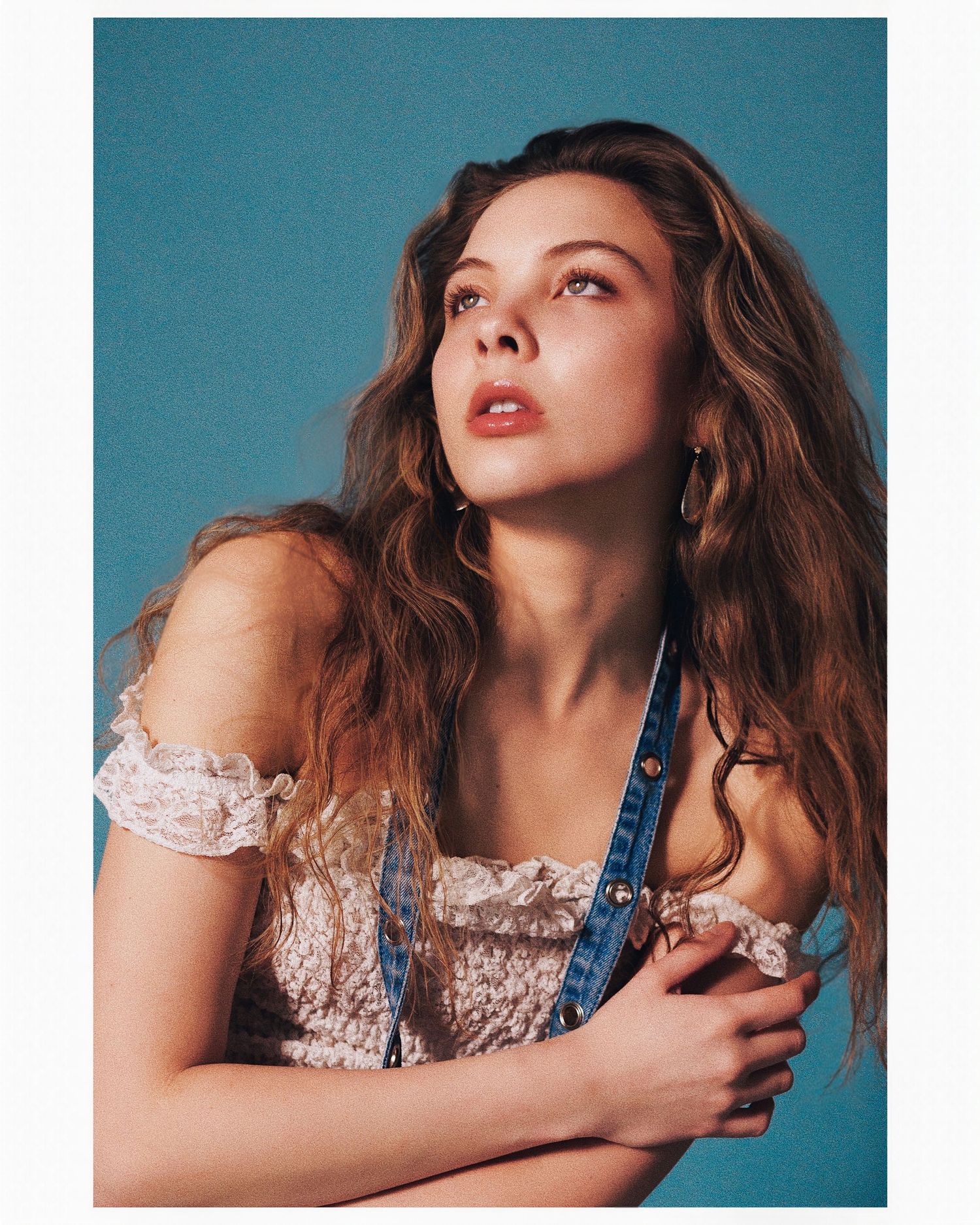 Fashion portrait against turquoise backdrop with delicate lace details and elegant poses.