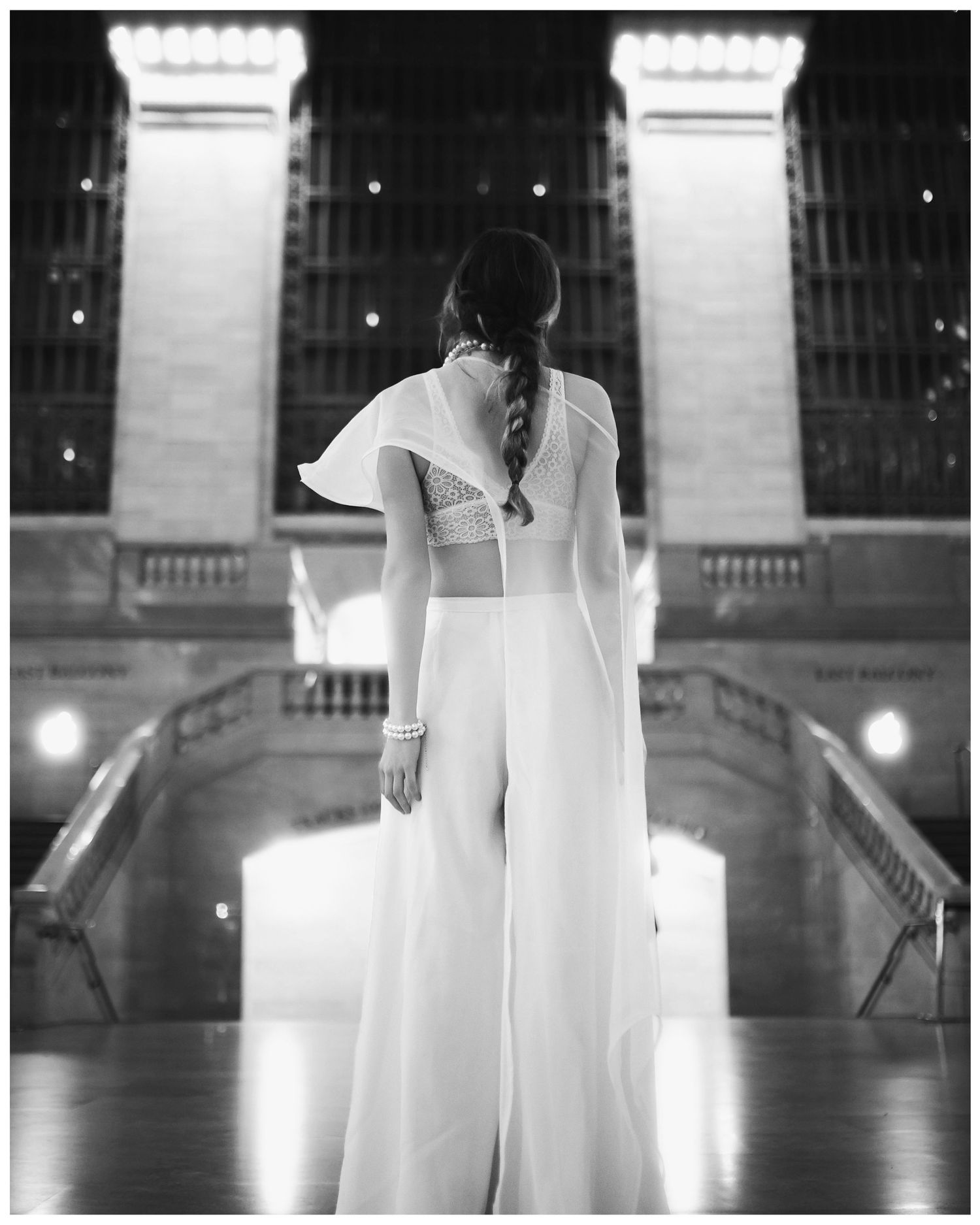 A series of haunting black and white photographs showing an ethereal figure in a flowing white dress standing in a grand corridor.