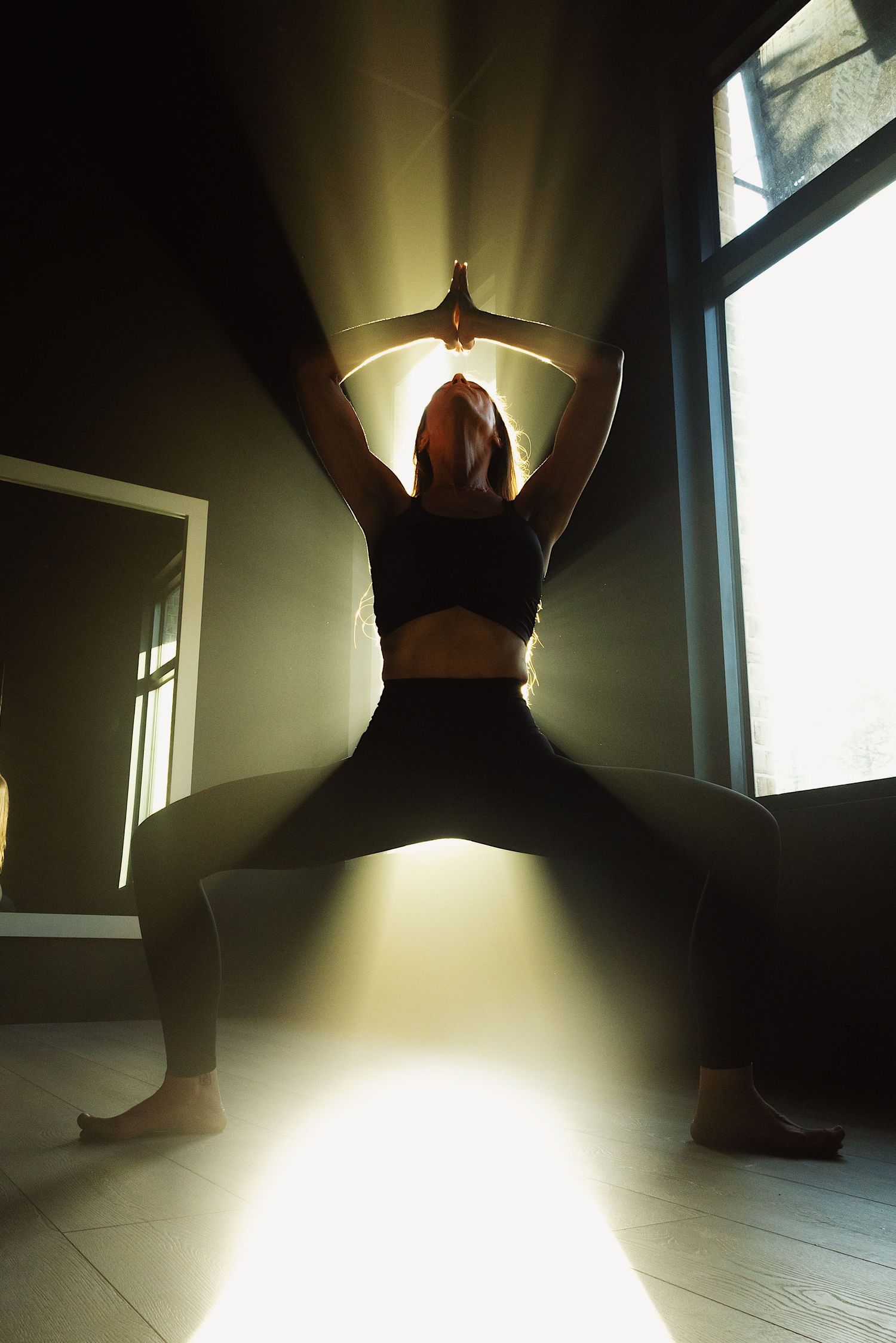 A series of dramatic silhouette photos showing a figure in a dark room illuminated by natural window light.