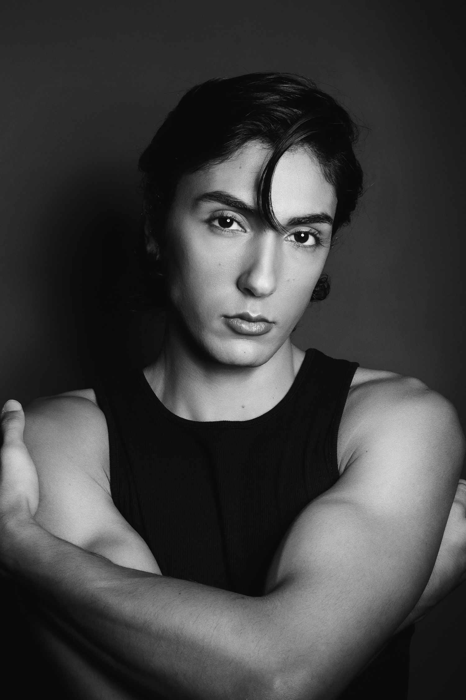 Artistic black and white portrait photo series showing dramatic shadows and lighting effects on a dark background.