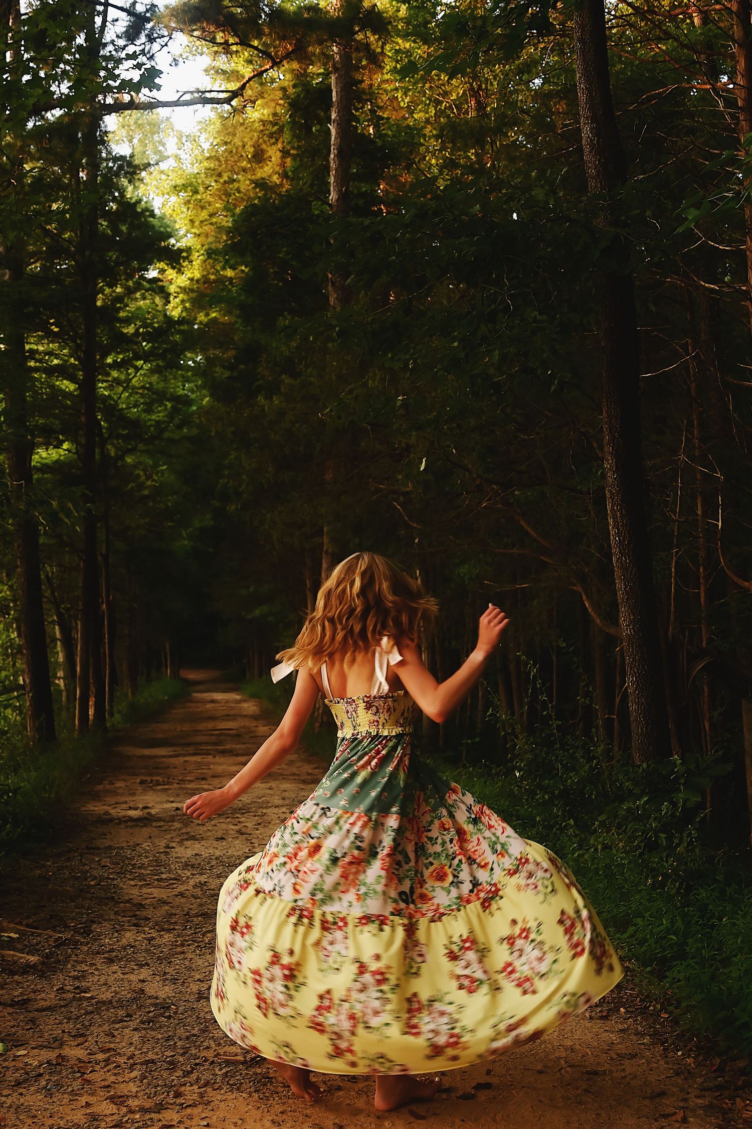 A floral dress twirls through a sunlit forest path creating a dreamy motion effect in a series of connected images.
