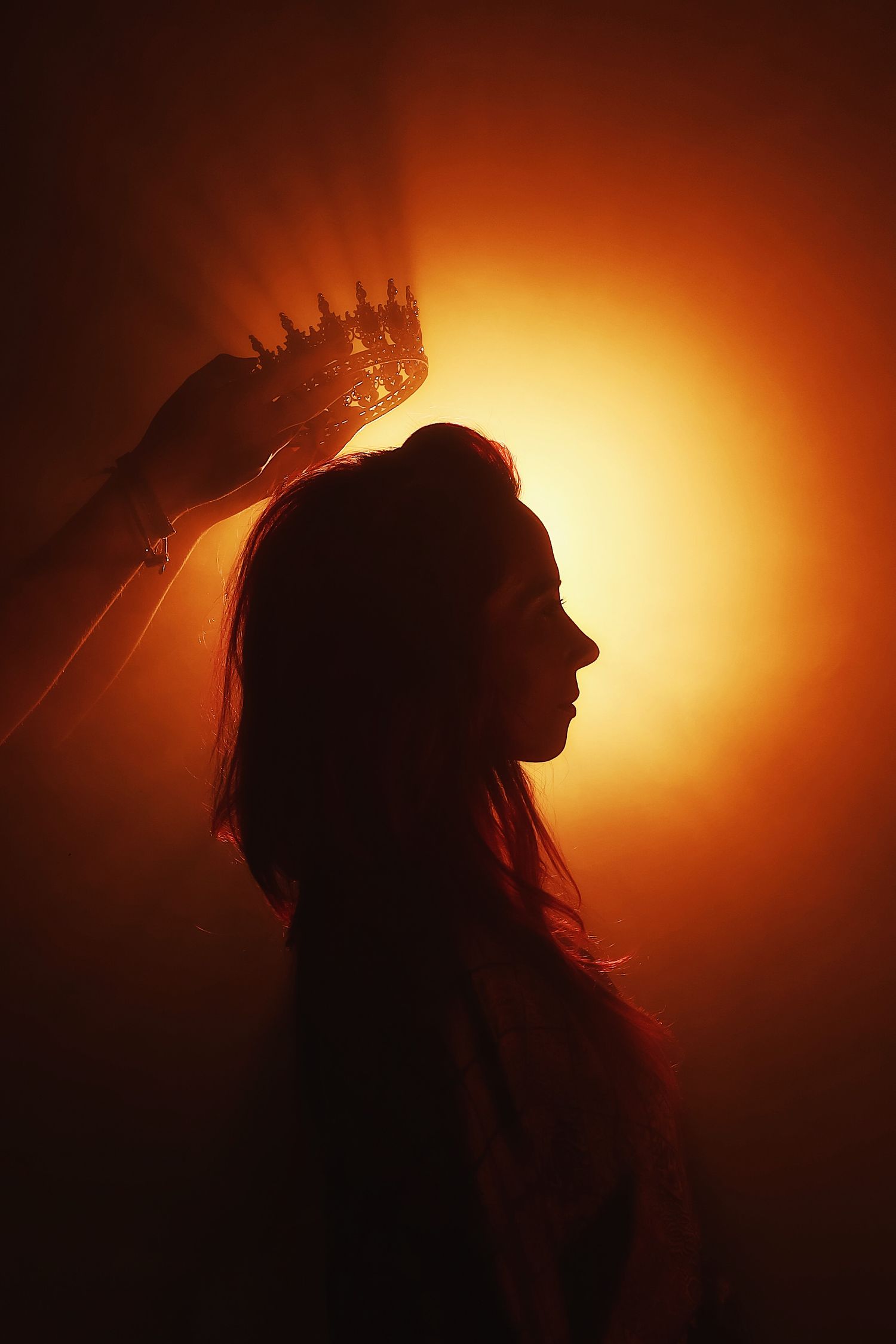 A silhouetted head in profile against a dramatic orange and black background captured in a series of artistic poses.