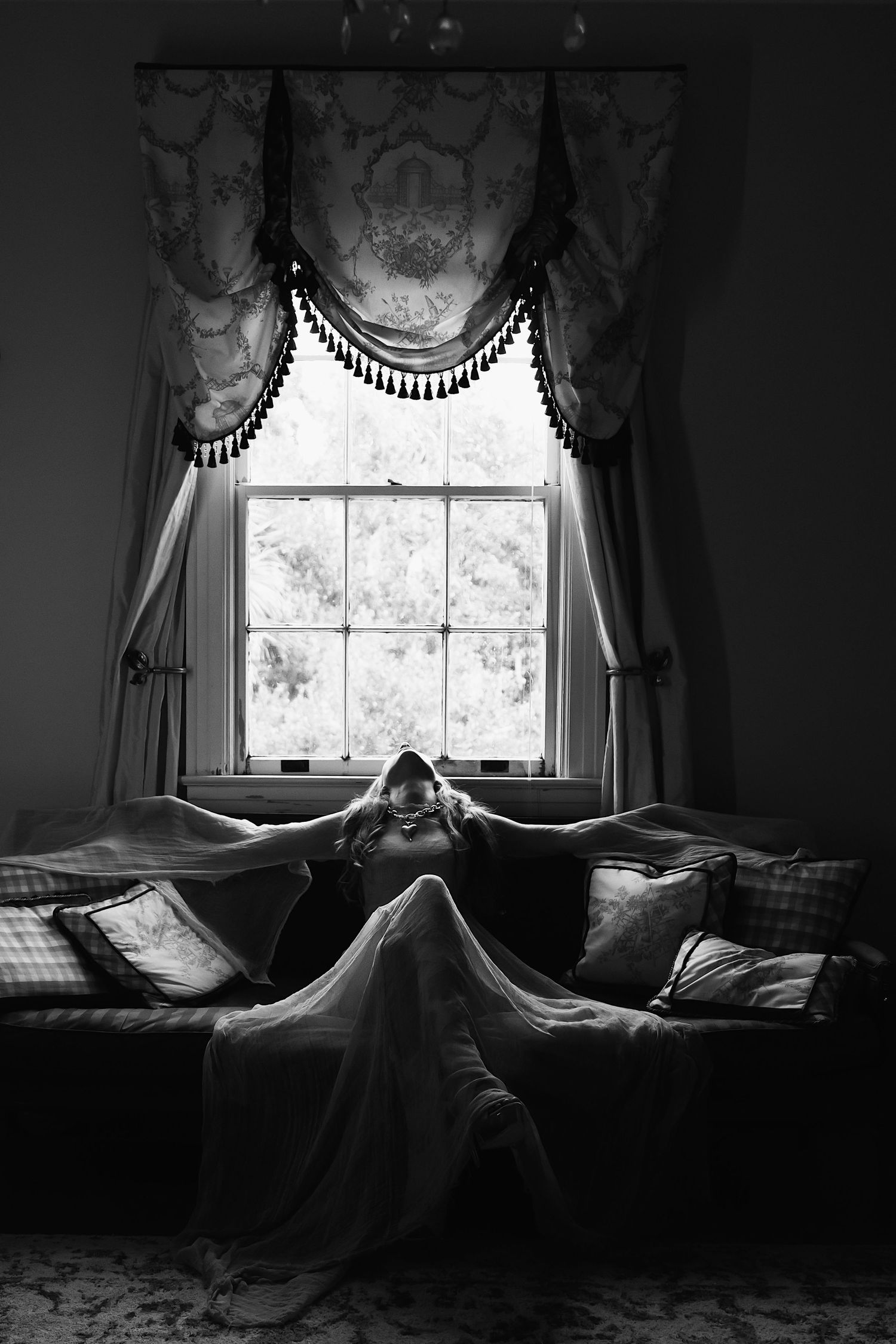 A dark and moody sequence of black and white photos showing a curtained window with light casting dramatic shadows.